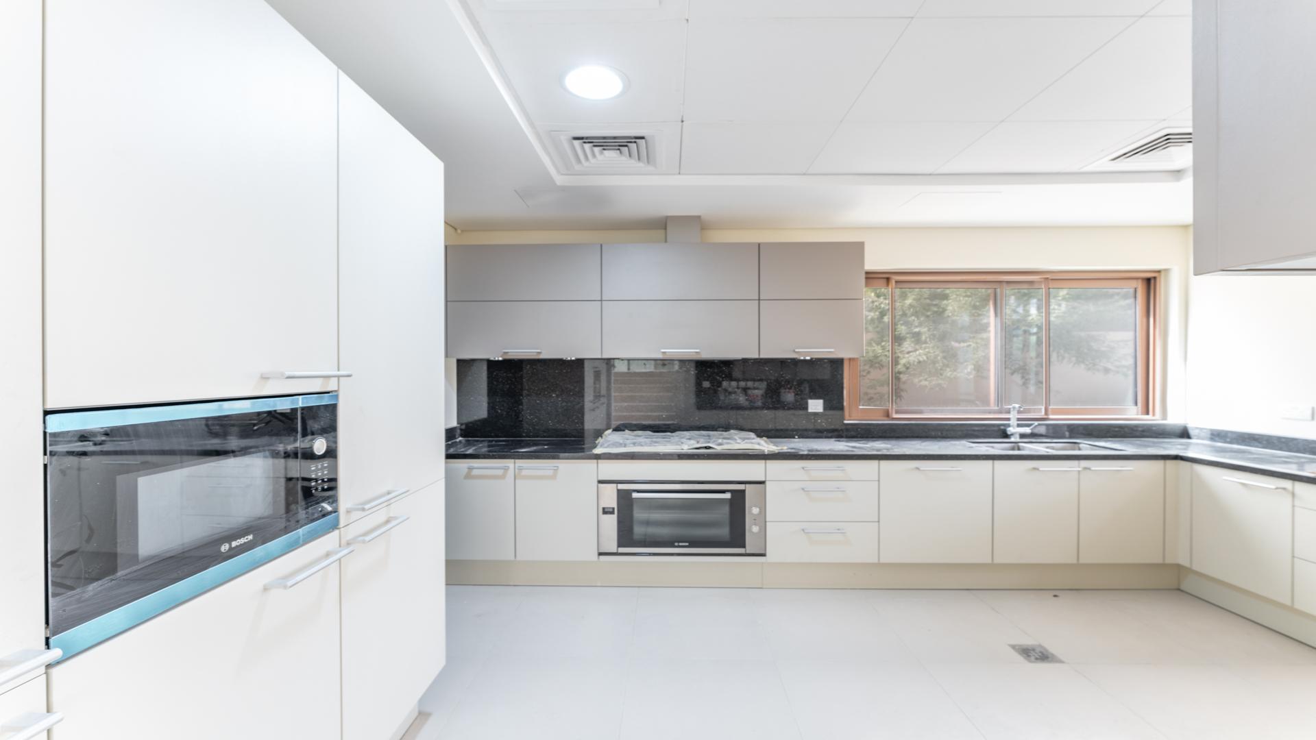 Spacious villa interior with large windows and park views in Meydan Gated Community