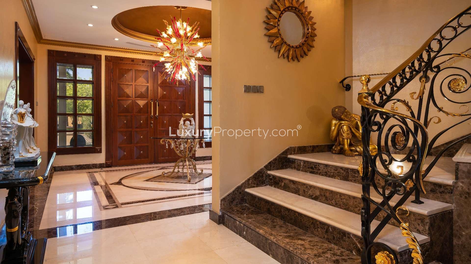 Luxurious villa poolside view with lush greenery in Emirates Hills, Sector R