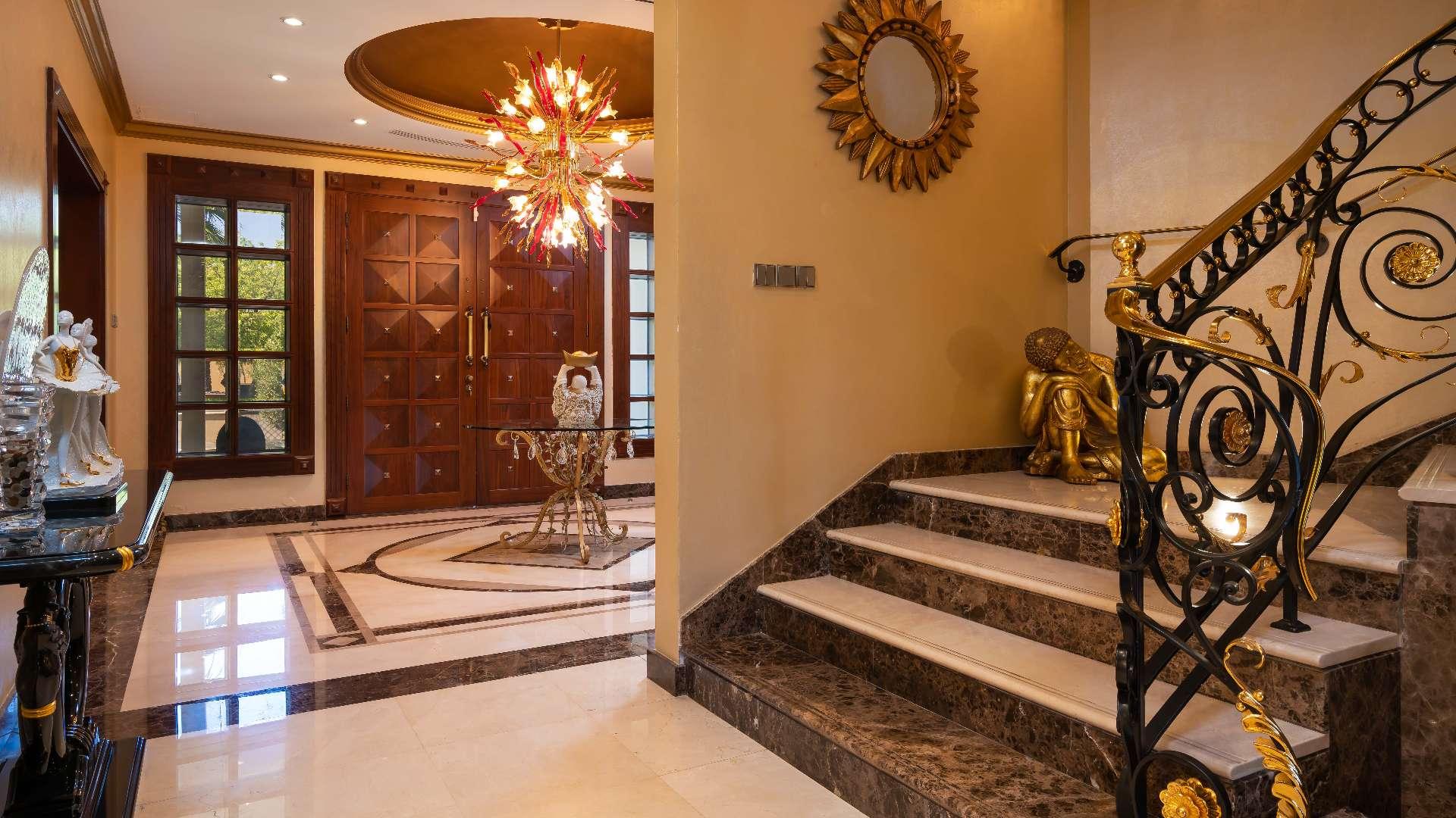 Luxurious villa poolside view with lush greenery in Emirates Hills, Sector R