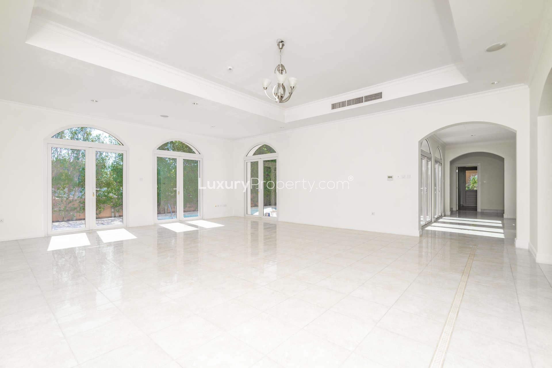 Spacious living area in Valencia style villa, Jumeirah Golf Estates, with elegant windows