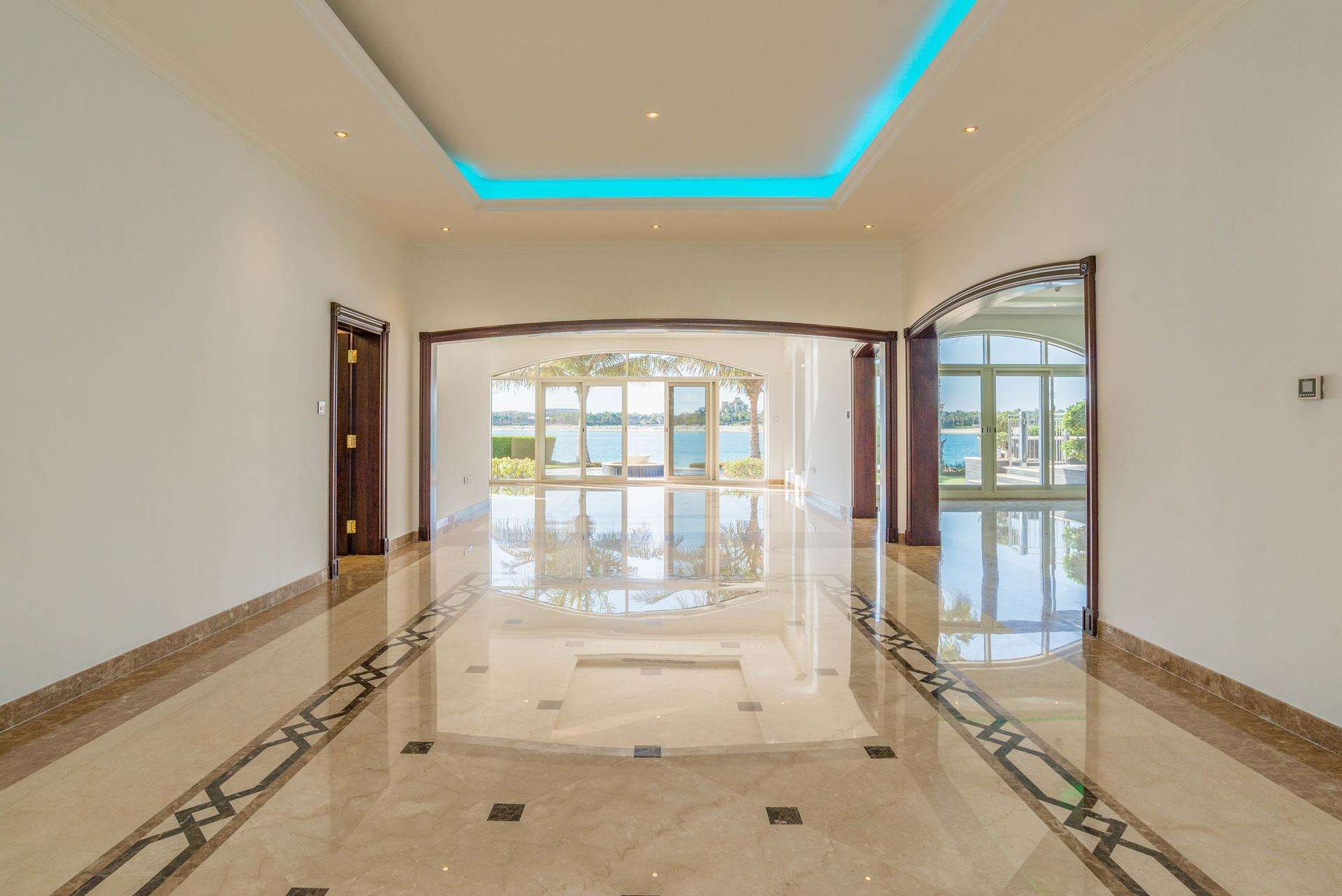 Luxurious villa staircase with elegant lighting and glass elevator in Palm Jumeirah