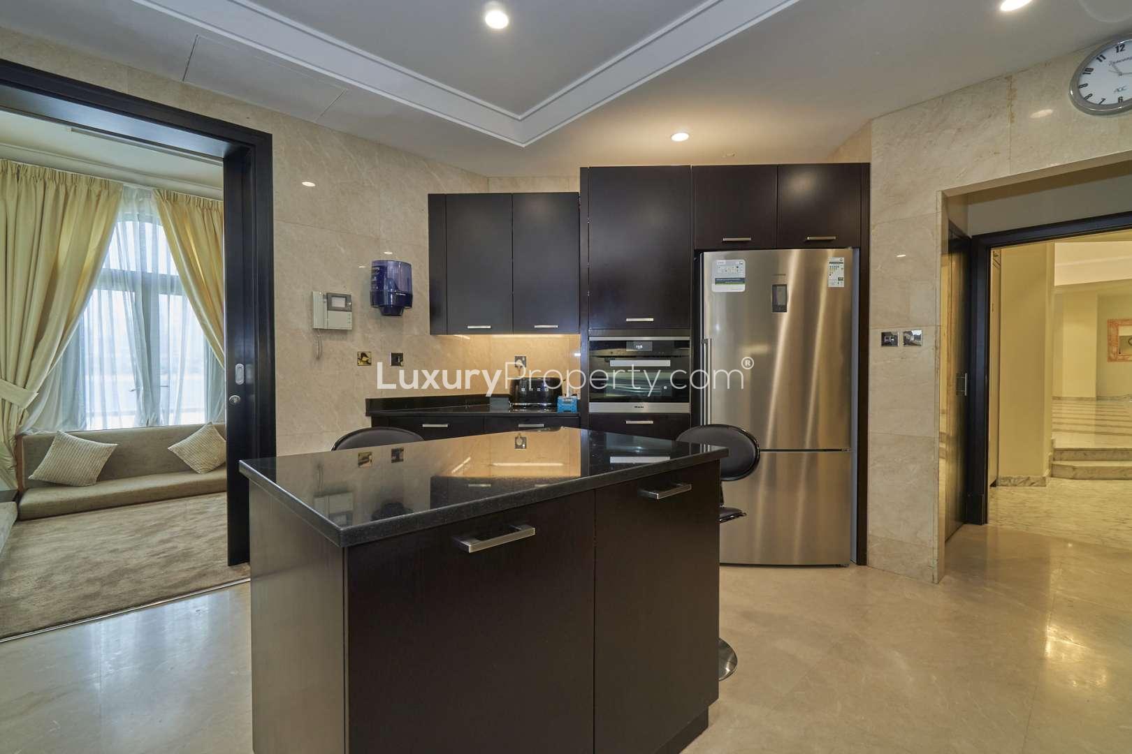 Spacious bedroom in 6-bedroom villa on Palm Jumeirah, featuring modern furnishings and ample light