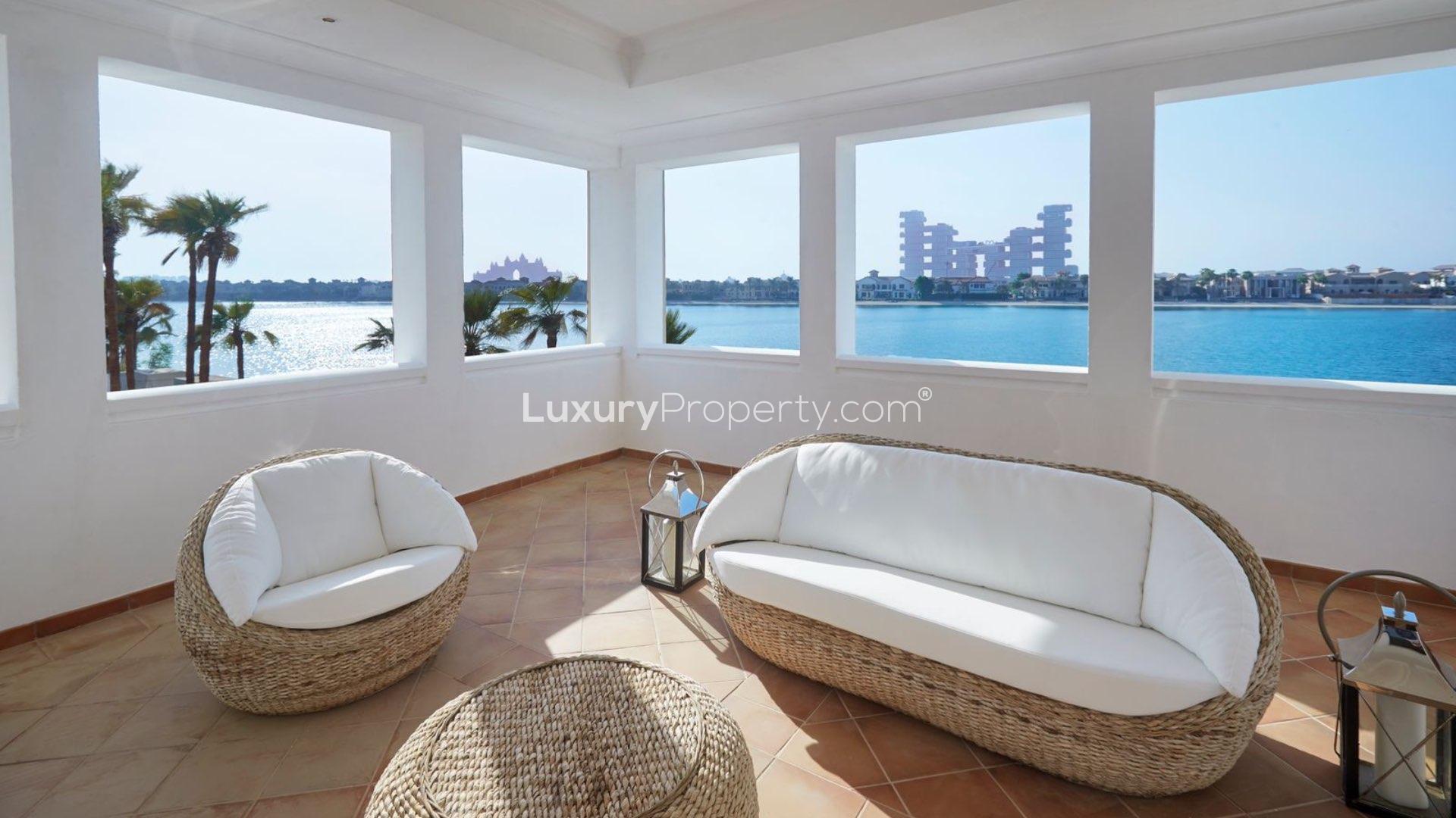 Luxury Palm Jumeirah villa poolside view with loungers and waterfront scenery