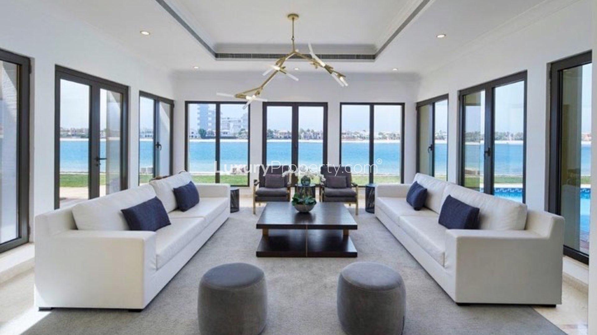 "Spacious terrace with wicker seating, ocean views at Palm Jumeirah Signature Villa, for rent.",Furnished living room with sea views in Palm Jumeirah Signature Villa for rent