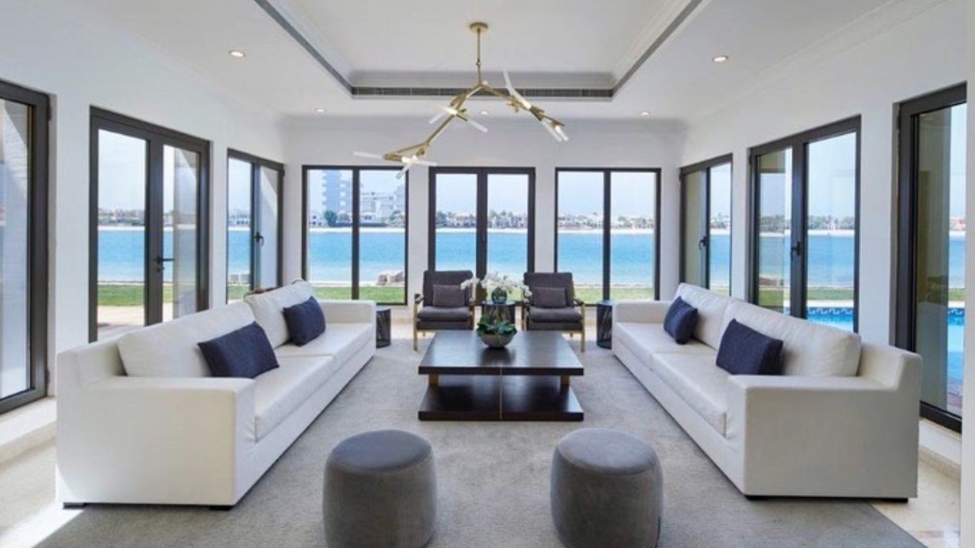 "Spacious terrace with wicker seating, ocean views at Palm Jumeirah Signature Villa, for rent.",Furnished living room with sea views in Palm Jumeirah Signature Villa for rent