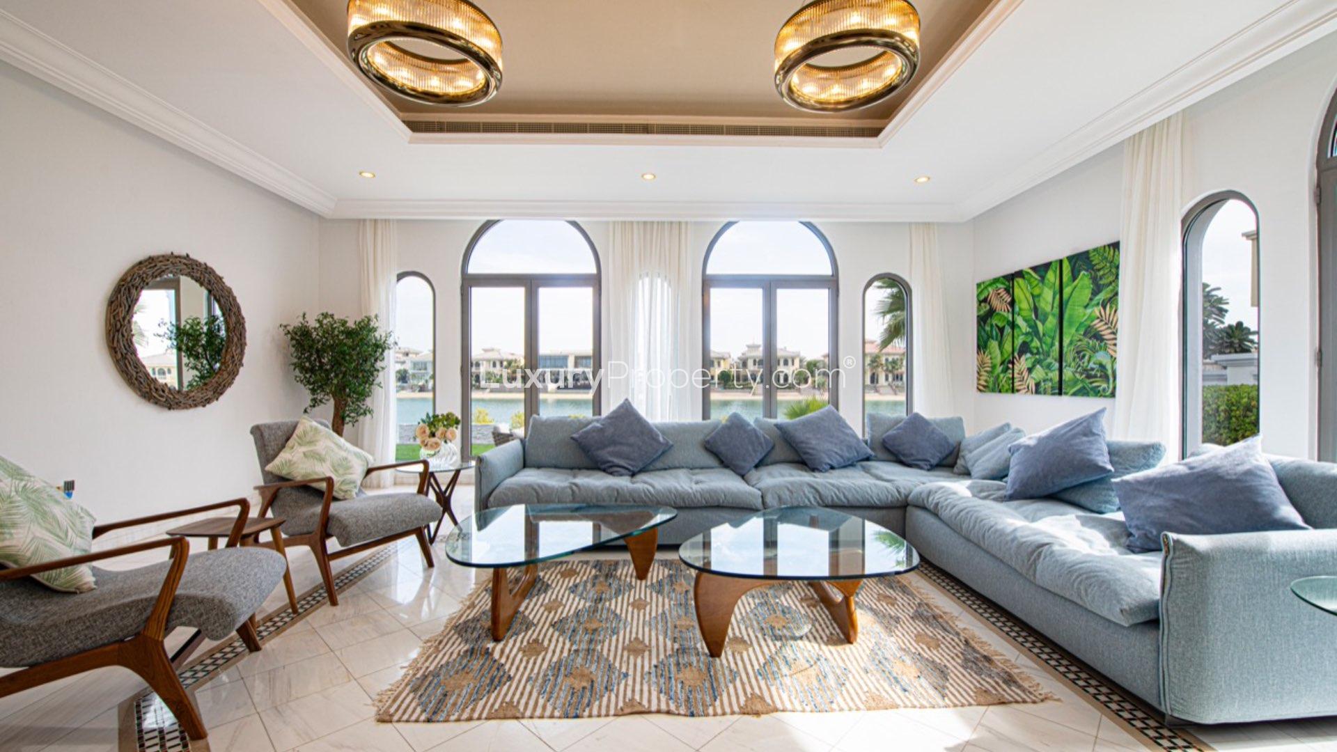 Luxurious beachfront villa exterior with patio, garden, and sea view in Palm Jumeirah