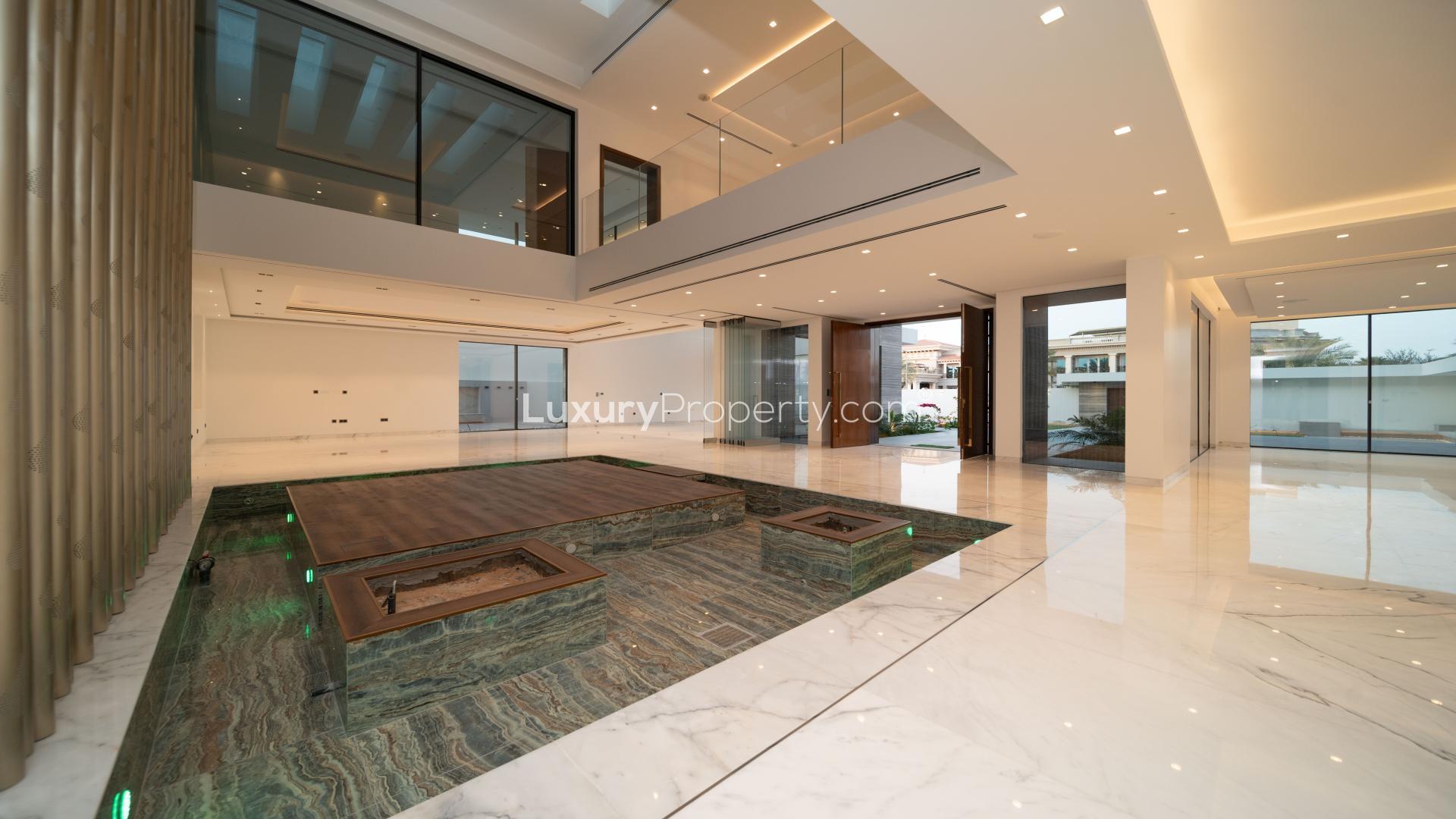 Modern custom-built villa exterior with pool in Umm al Sheif, Dubai at dusk