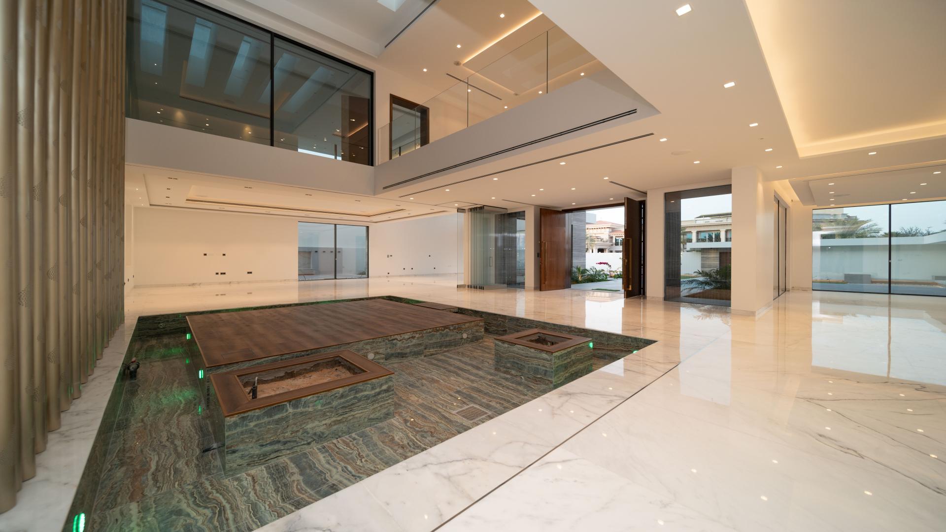 Modern custom-built villa exterior with pool in Umm al Sheif, Dubai at dusk