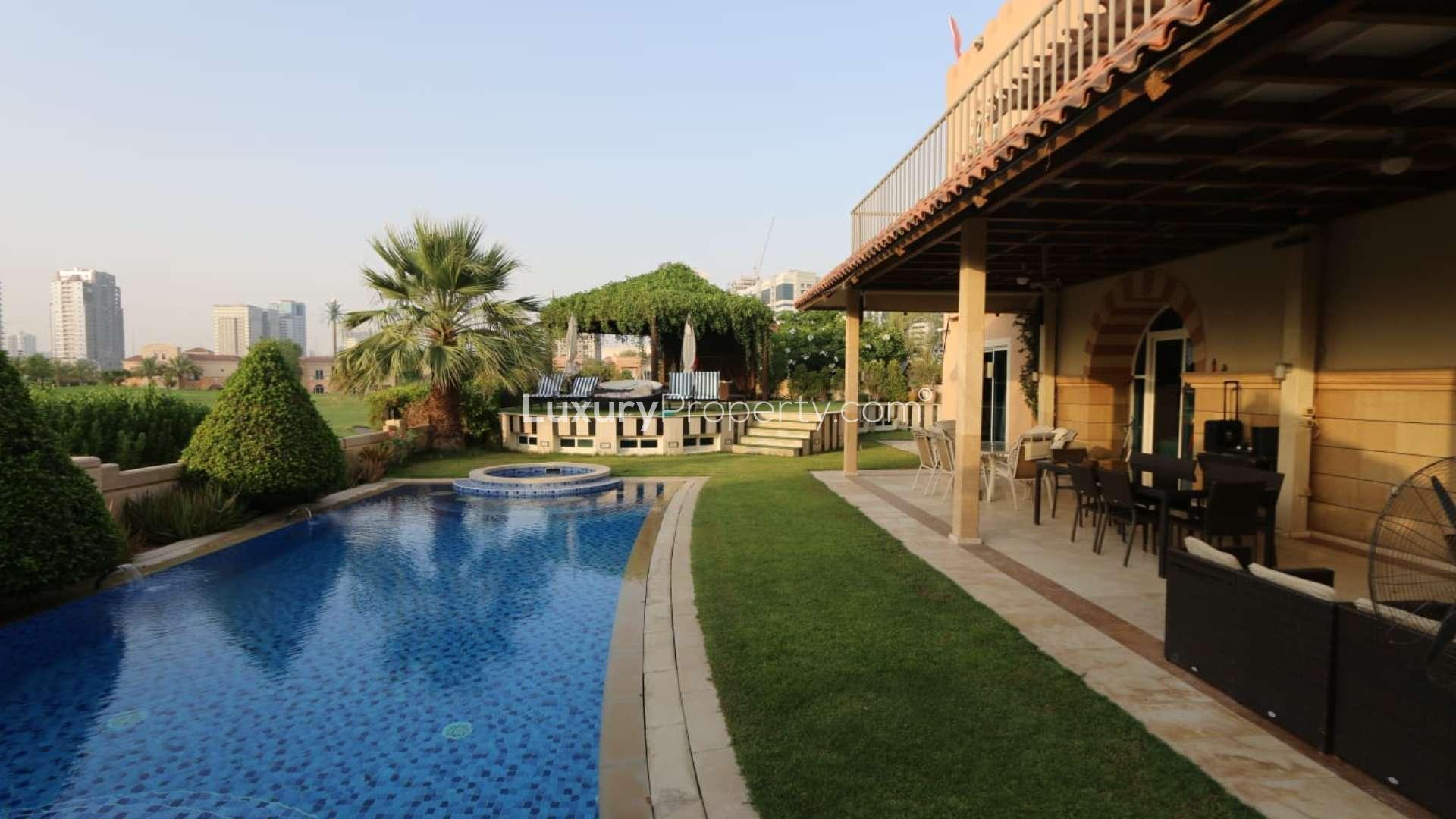 Luxurious villa balcony with seating, overlooking Dubai Sports City skyline in Victory Heights