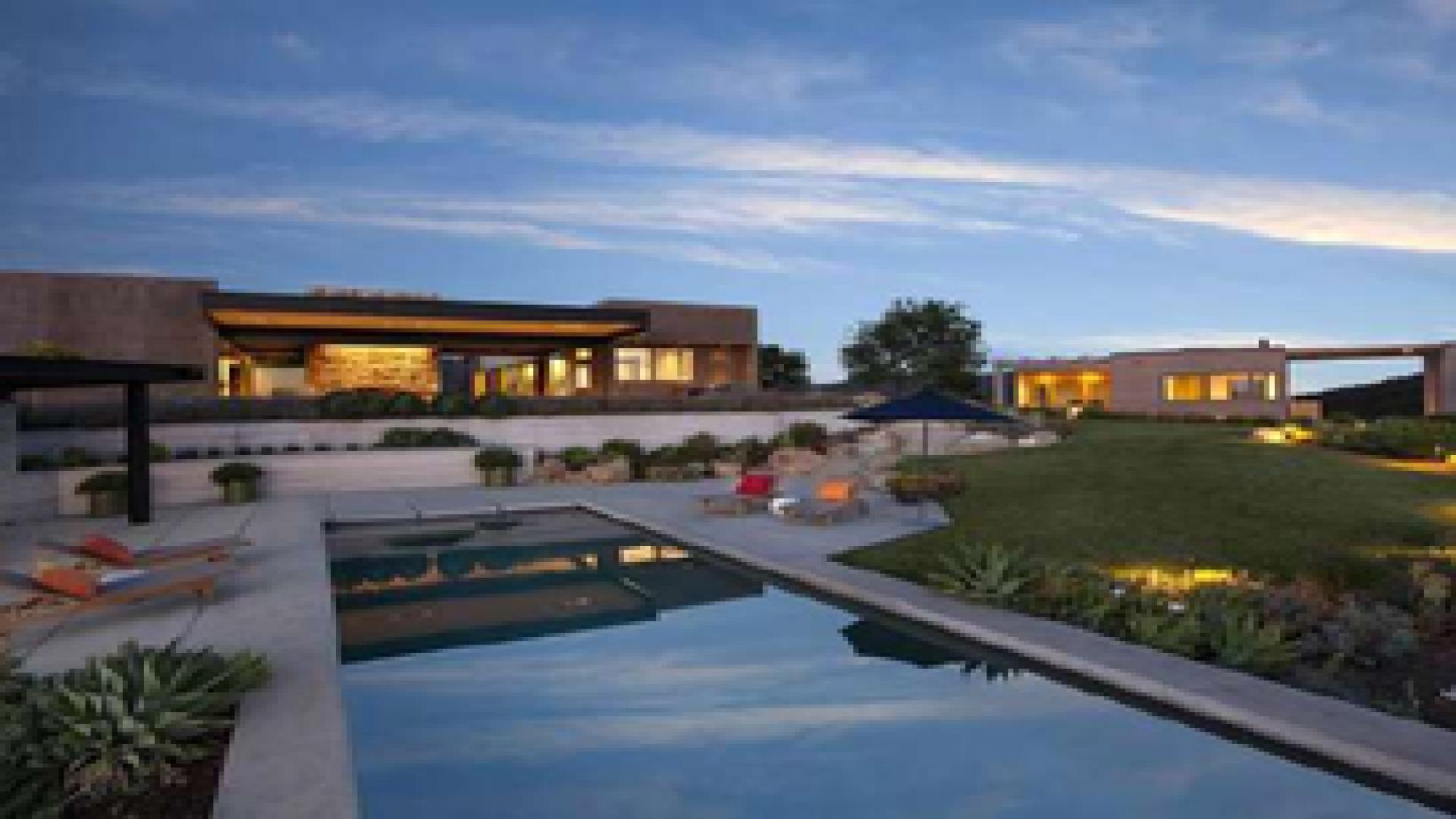 "Luxury villa with tropical garden and pond in Eden Hills, Mohamed Bin Zayed City.",Luxurious 6-bedroom villa with pool at sunset, Eden Hills, Mohamed Bin Zayed City