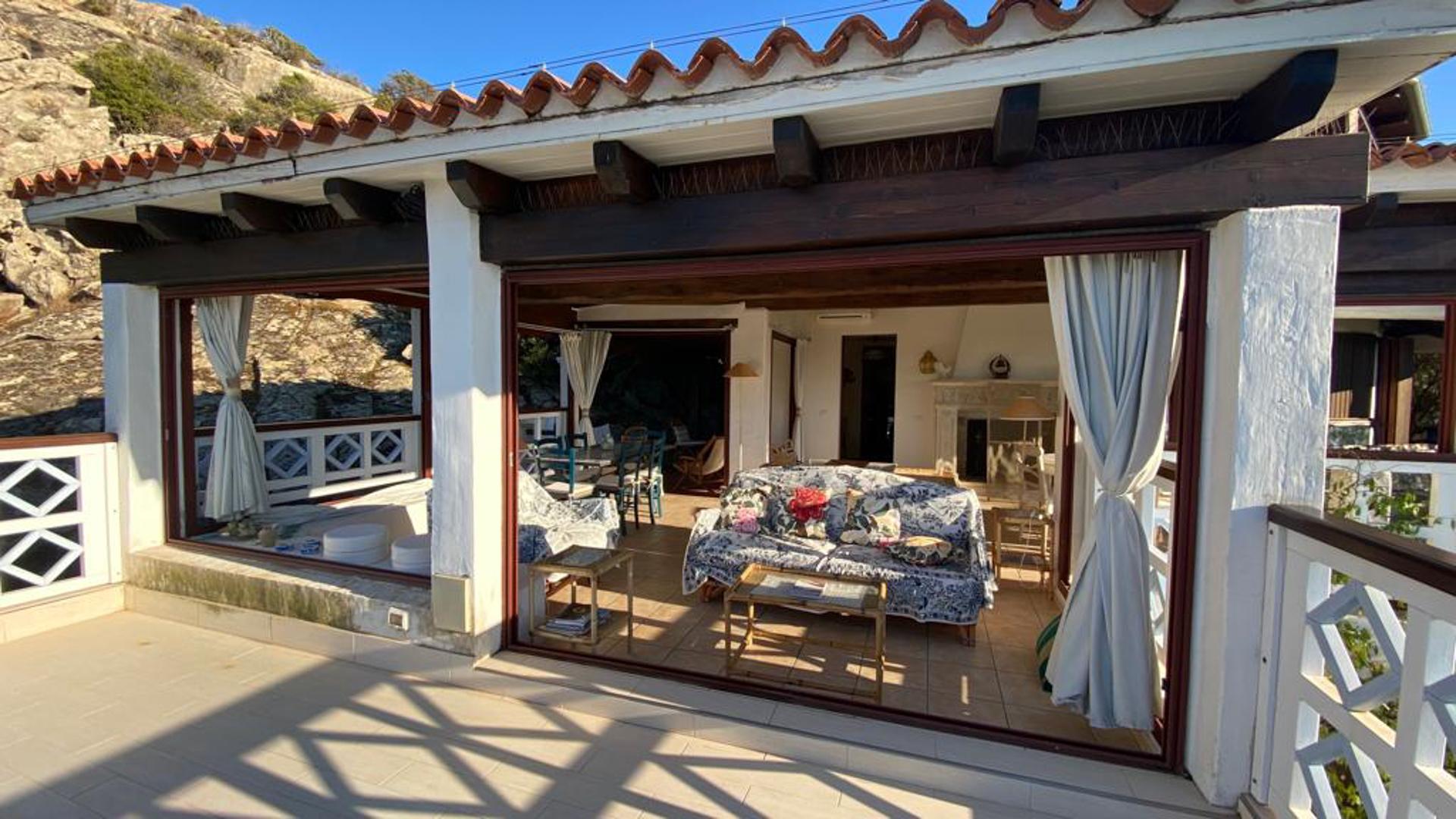 Secluded Sardinian villa view with lush greenery and ocean, Porto Rotondo, Olbia