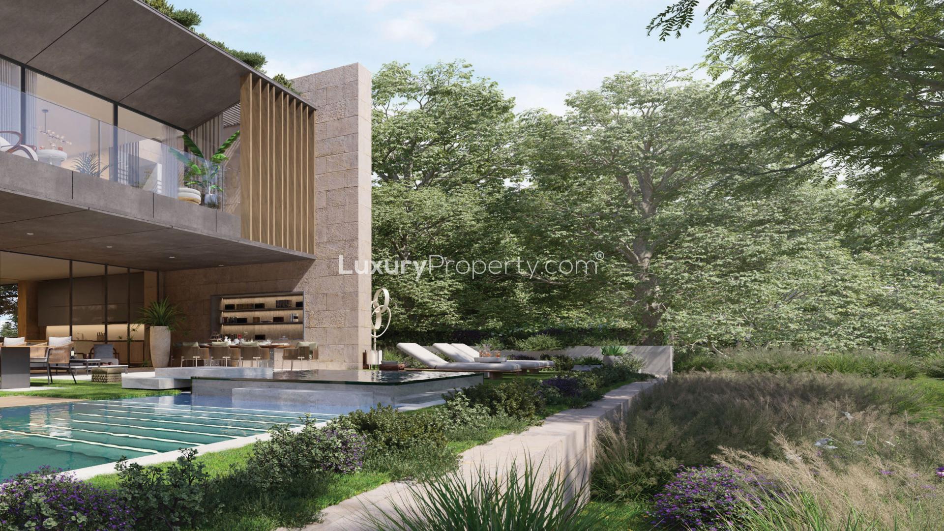 Modern dining area in Tilal Al Ghaf villa with elegant decor and staircase view