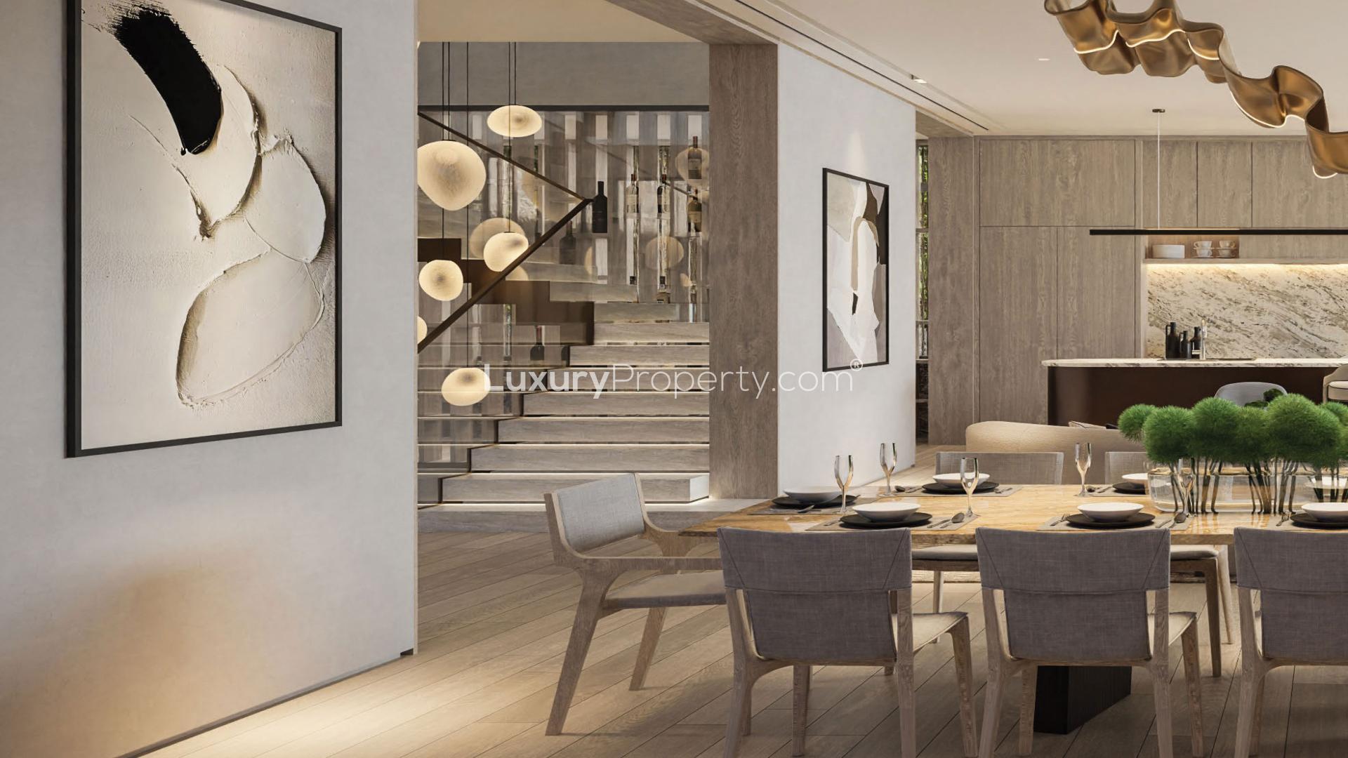 Luxurious outdoor seating area with fire pit at Tilal Al Ghaf villa for sale