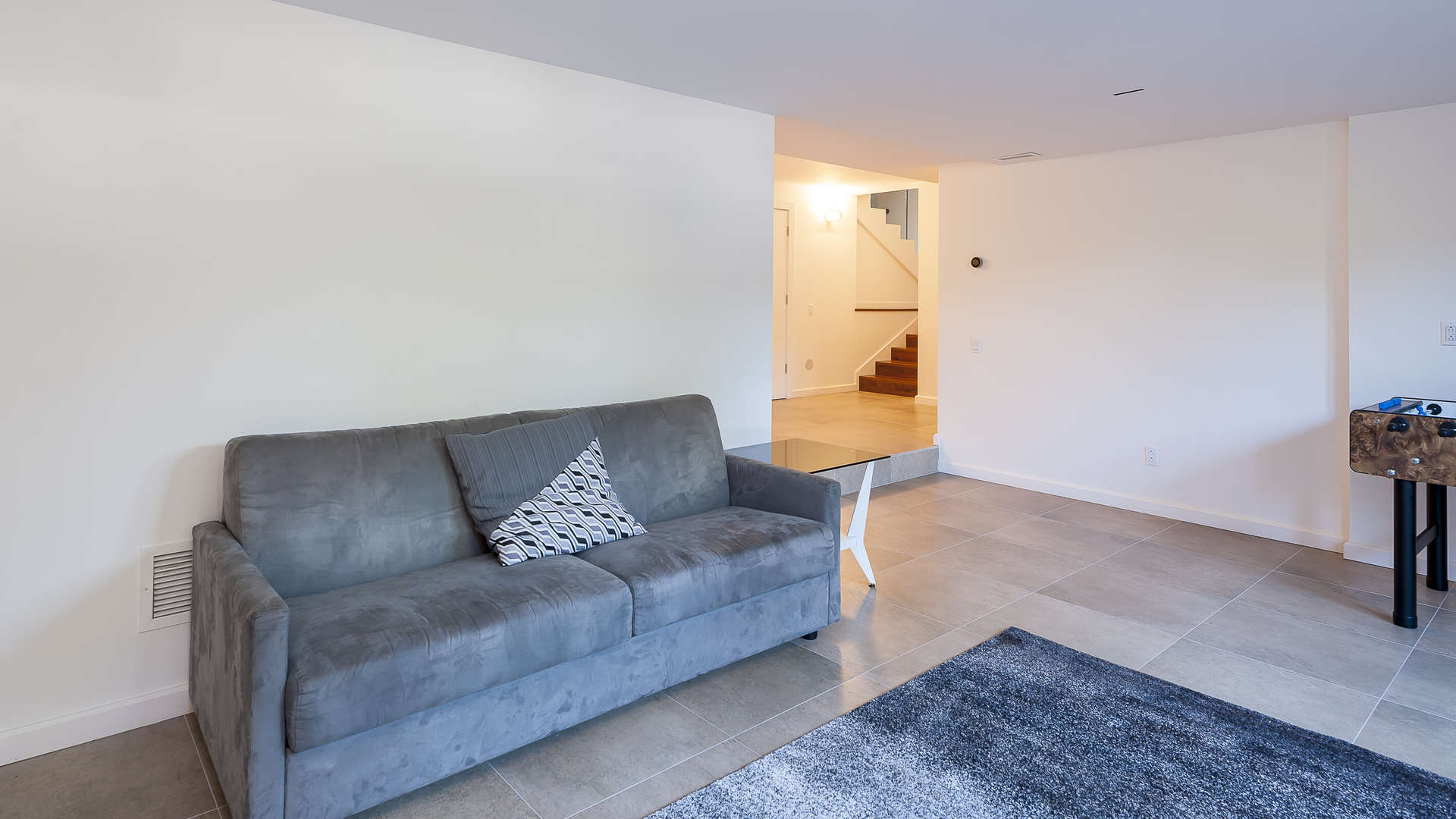 Spacious recreational room with foosball table in Westmount villa, Montreal