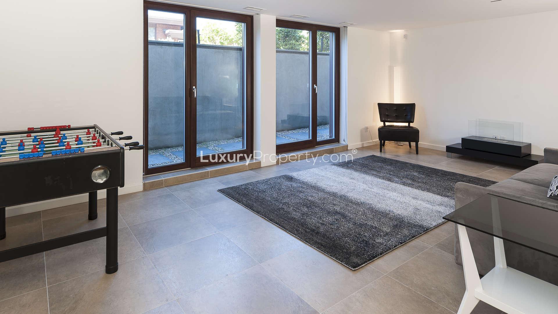 Spacious living room with modern fireplace in Westmount villa, Montreal