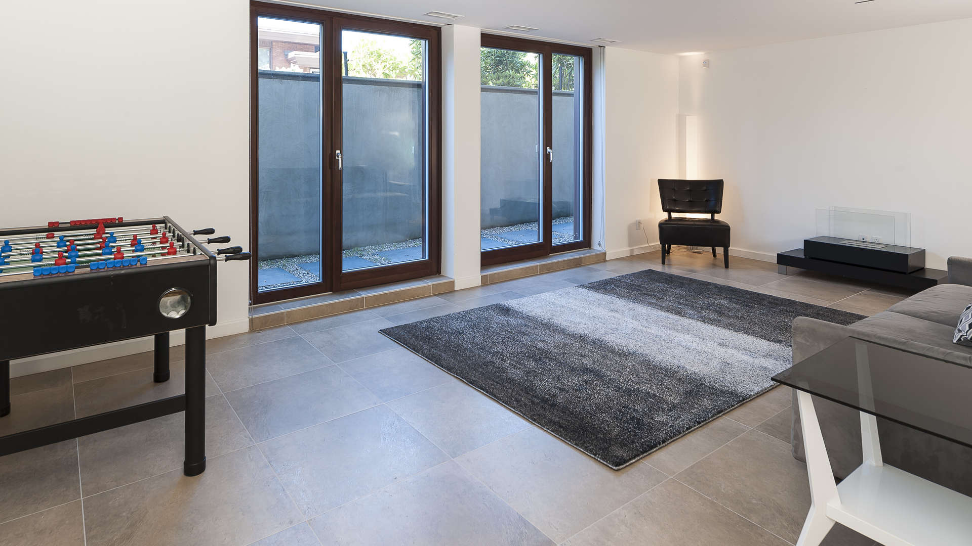 Spacious living room with modern fireplace in Westmount villa, Montreal