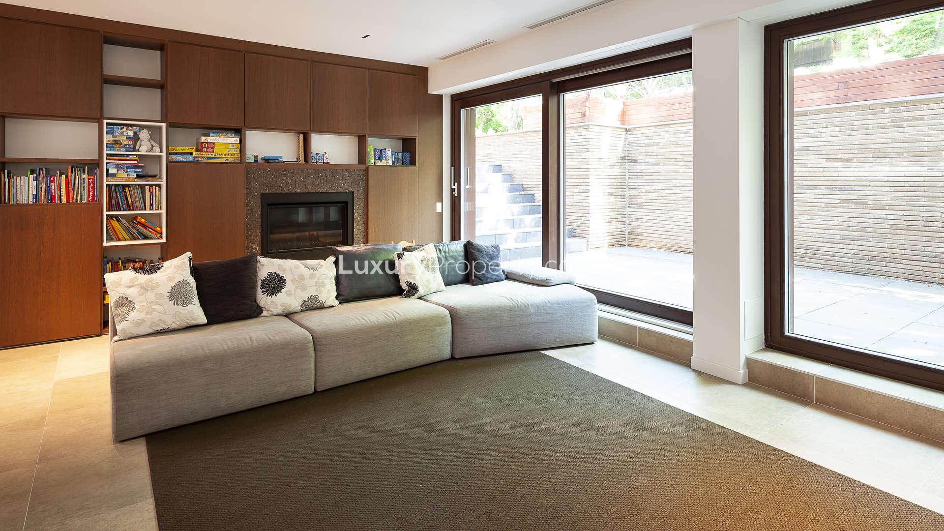 Modern six-bedroom villa exterior in Westmount, Montreal, surrounded by greenery and blue skies