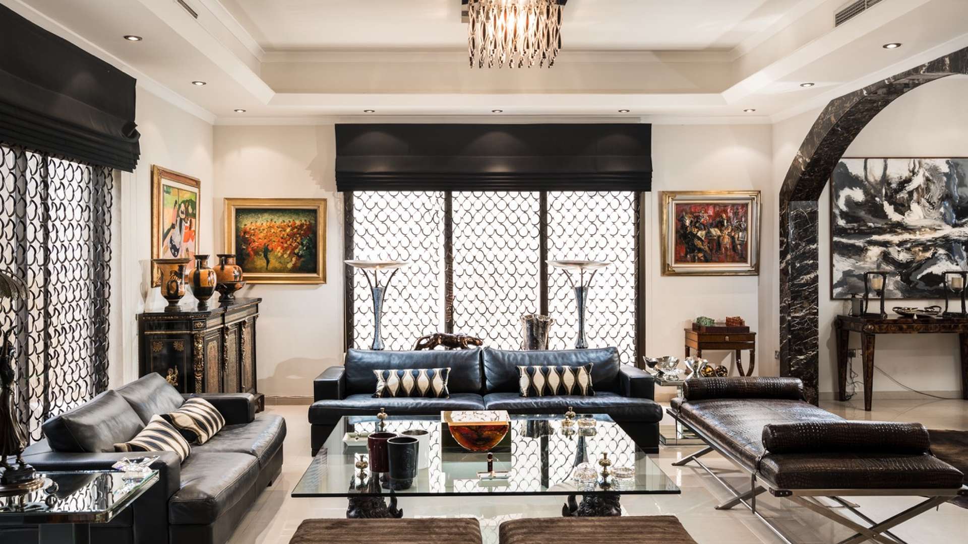 Luxurious bedroom in Al Manara villa with elegant decor and large window view