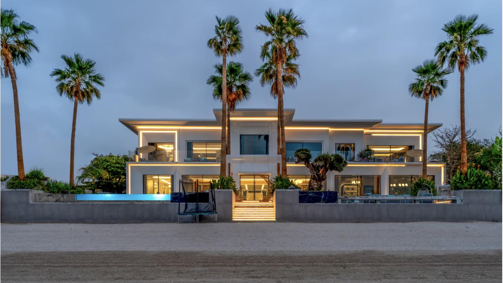 Breathtaking beachfront villa with pool, palm trees, and sunset views in Palm Jumeirah