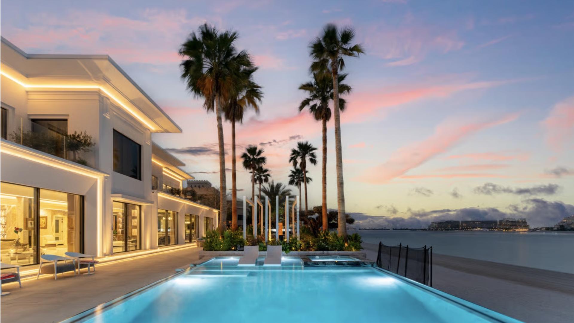 Luxurious beachfront villa patio with modern seating, ambient lighting, and palm trees, Palm Jumeirah