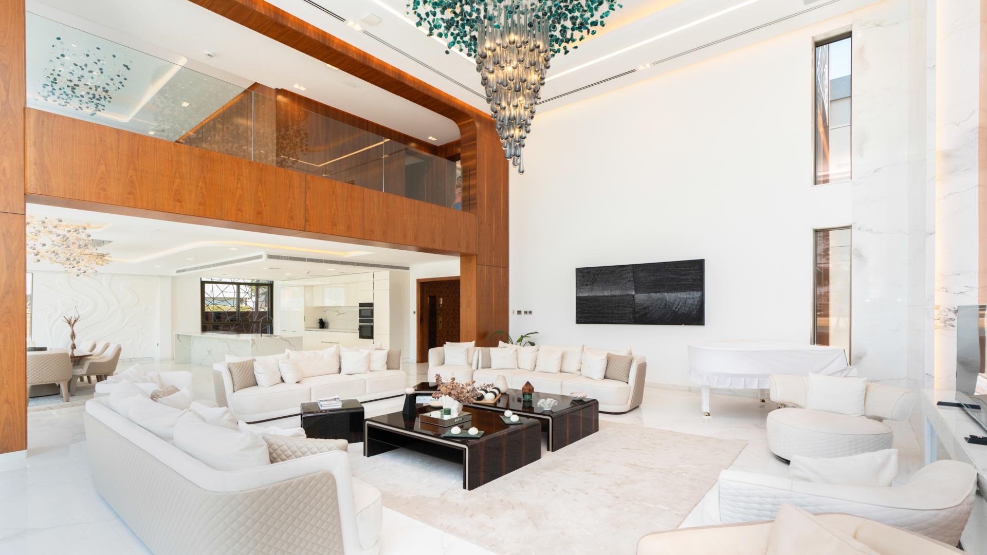 Luxurious living room in 6-bedroom villa, Palm Jumeirah, featuring elegant decor and chandelier