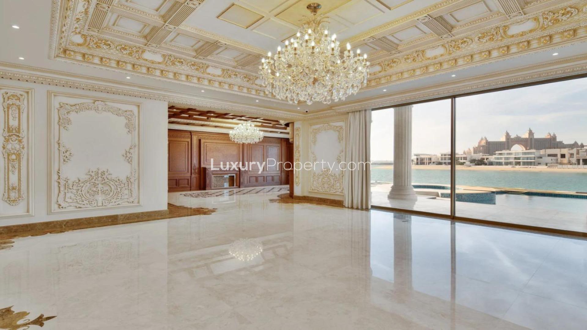 Luxurious grand staircase in Palm Jumeirah villa, featuring elegant chandeliers and sea views