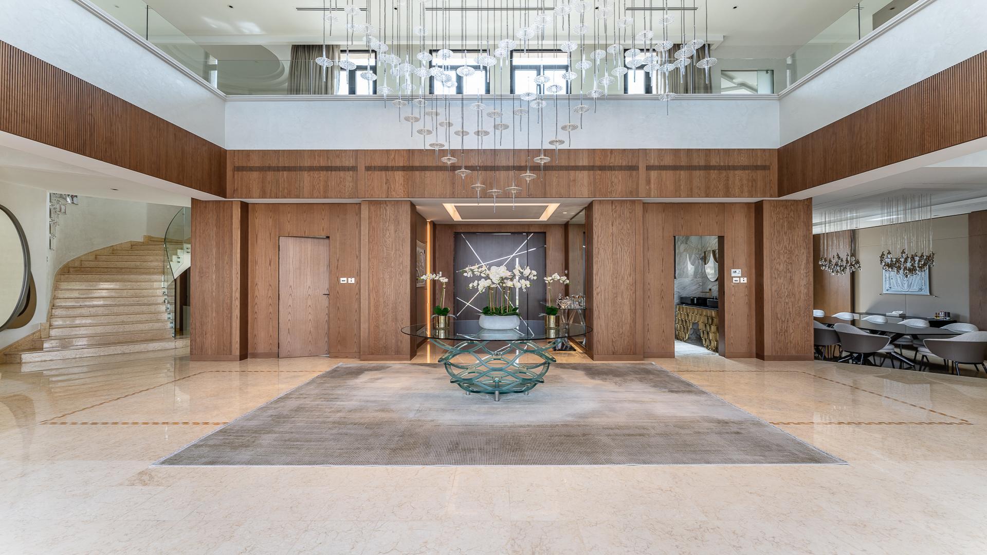 Spacious living room in Palm Jumeirah villa with modern decor and large windows