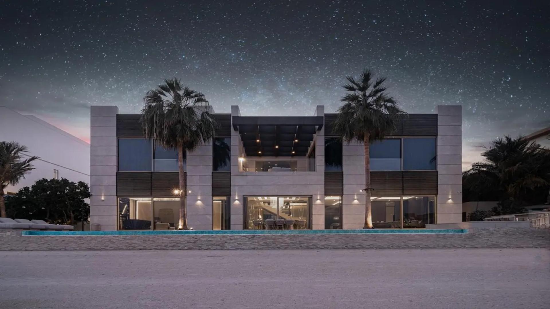 Beachfront view from luxury villa in Palm Jumeirah, showcasing skyline and serene waters