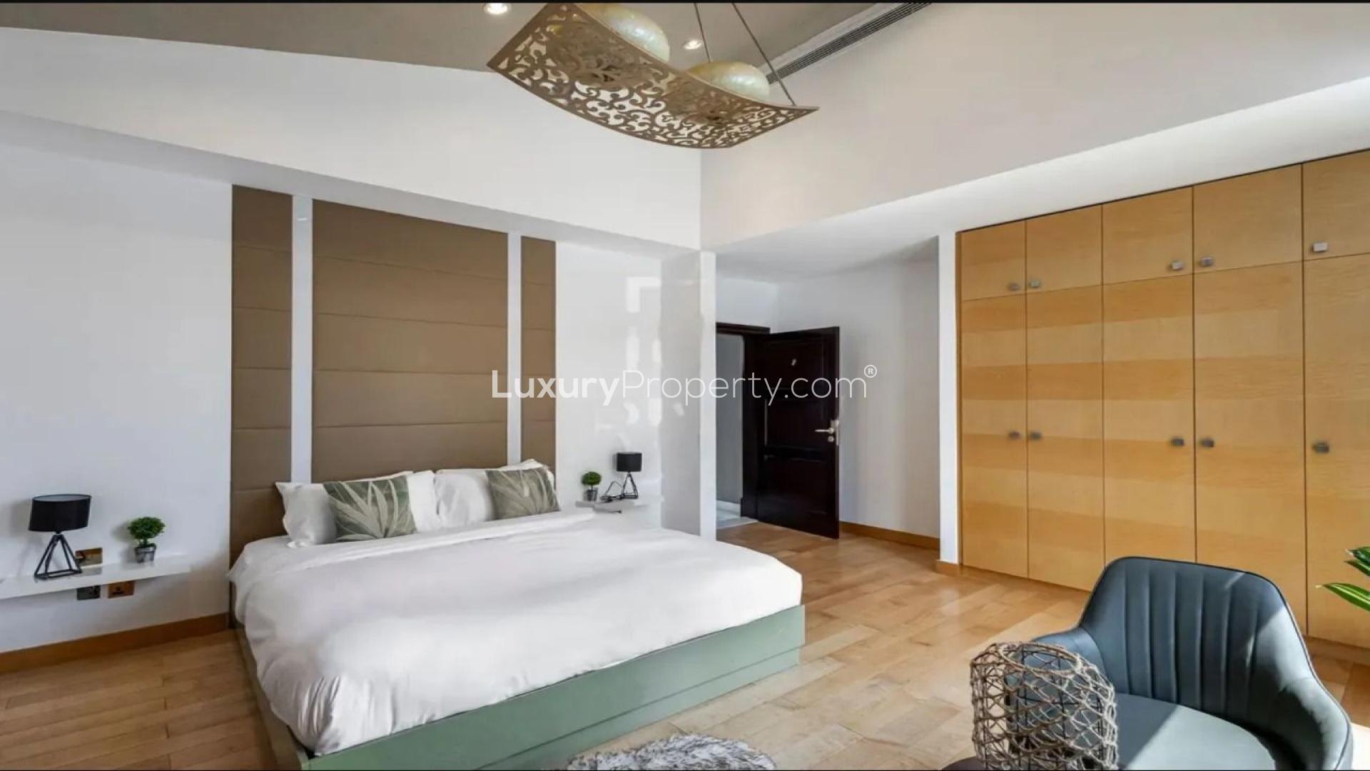"Modern 6-bedroom villa for sale, Signature Villas, Palm Jumeirah, spacious driveway view.",Luxurious bedroom in Palm Jumeirah villa, featuring modern design and spacious layout