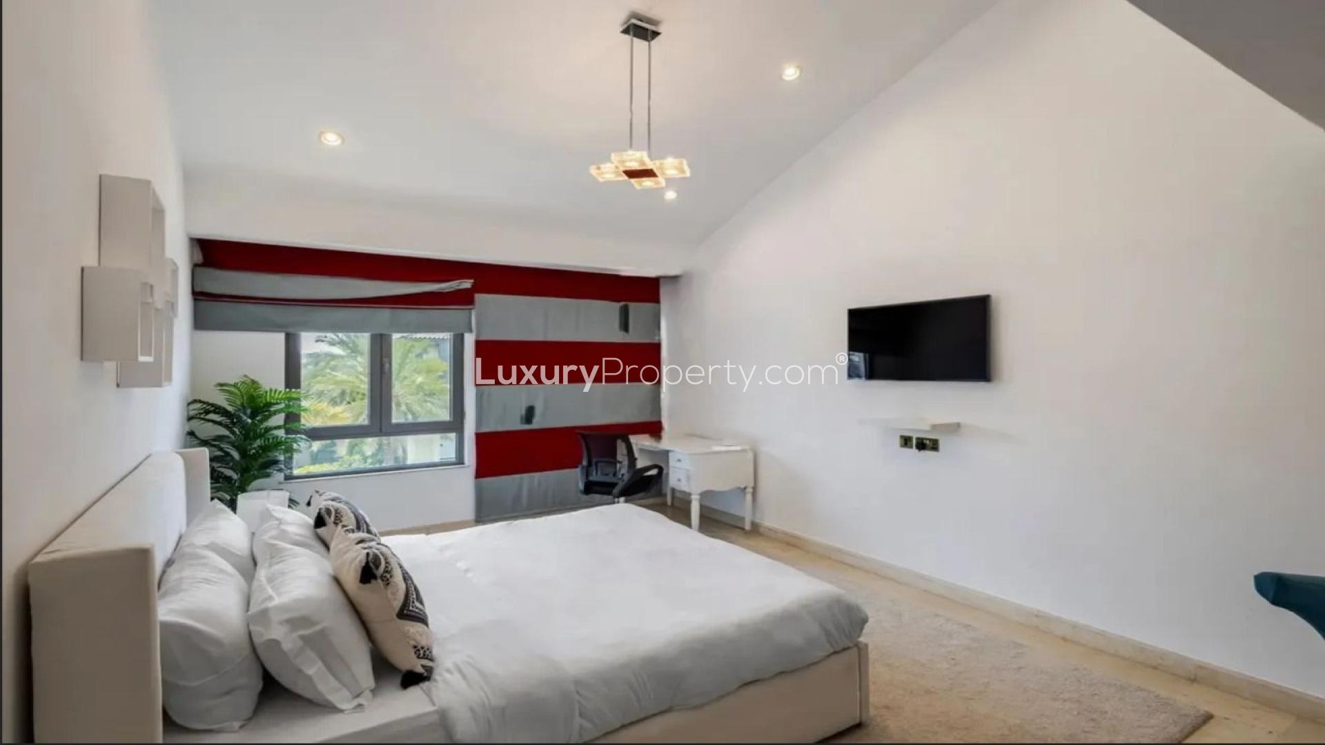 Luxurious bedroom in Palm Jumeirah villa with modern decor and window view