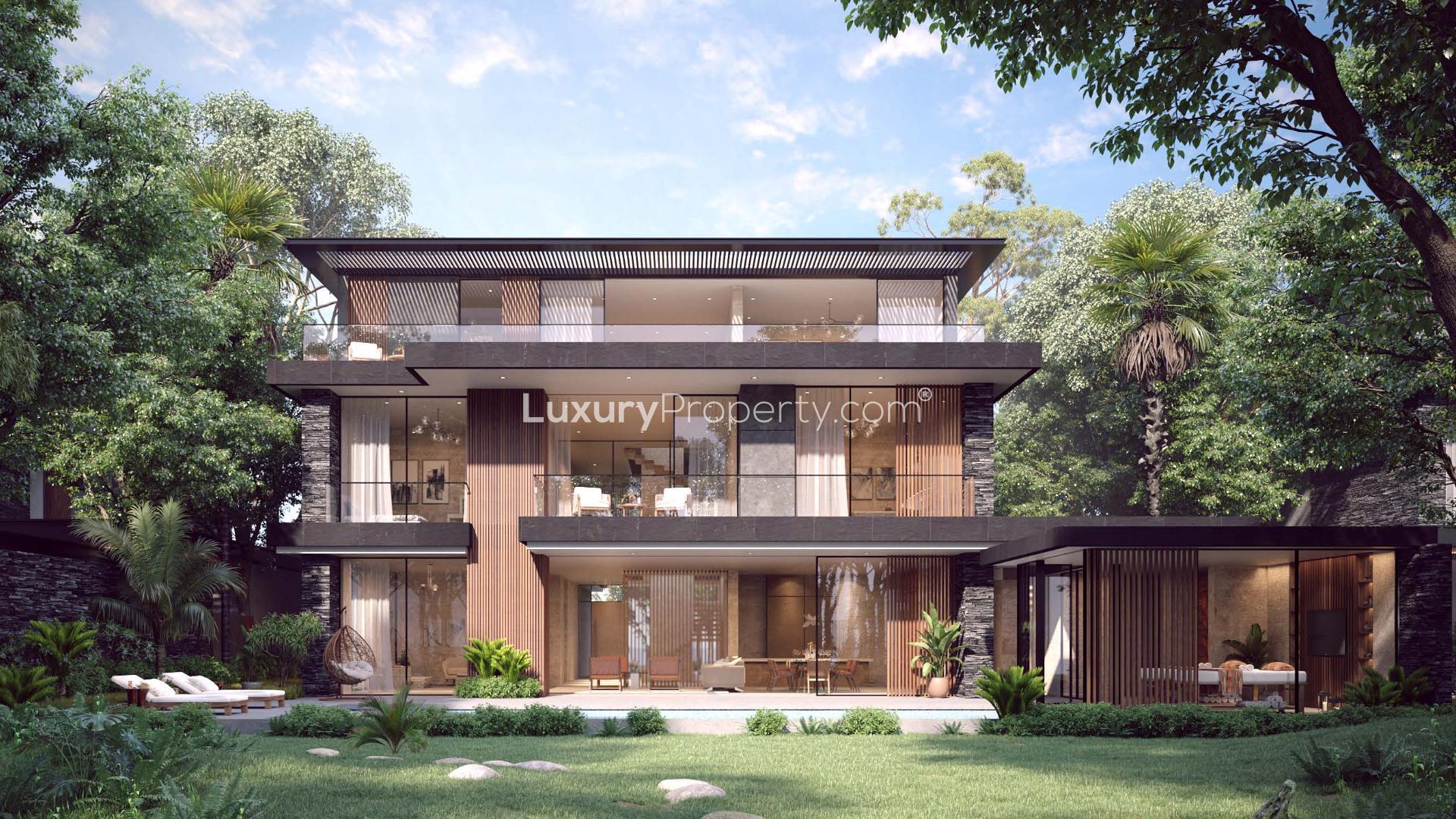 Contemporary villa exterior with garage in Alaya, Tilal Al Ghaf, surrounded by lush greenery