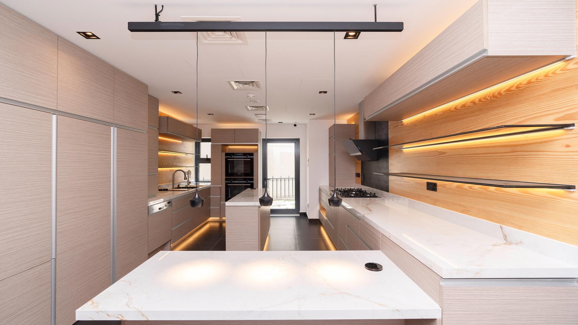 Modern kitchen in 6-bed Jumeirah Islands villa, featuring sleek cabinetry and spacious layout