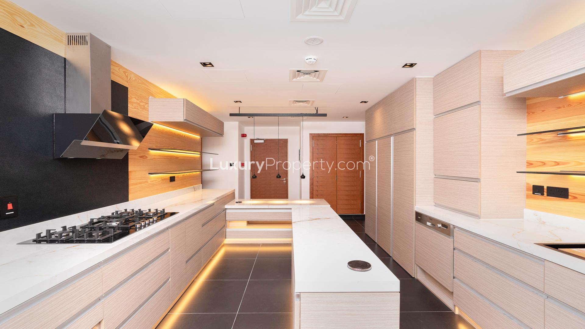 Luxurious open-plan villa interior with large windows and pool view in Jumeirah Islands