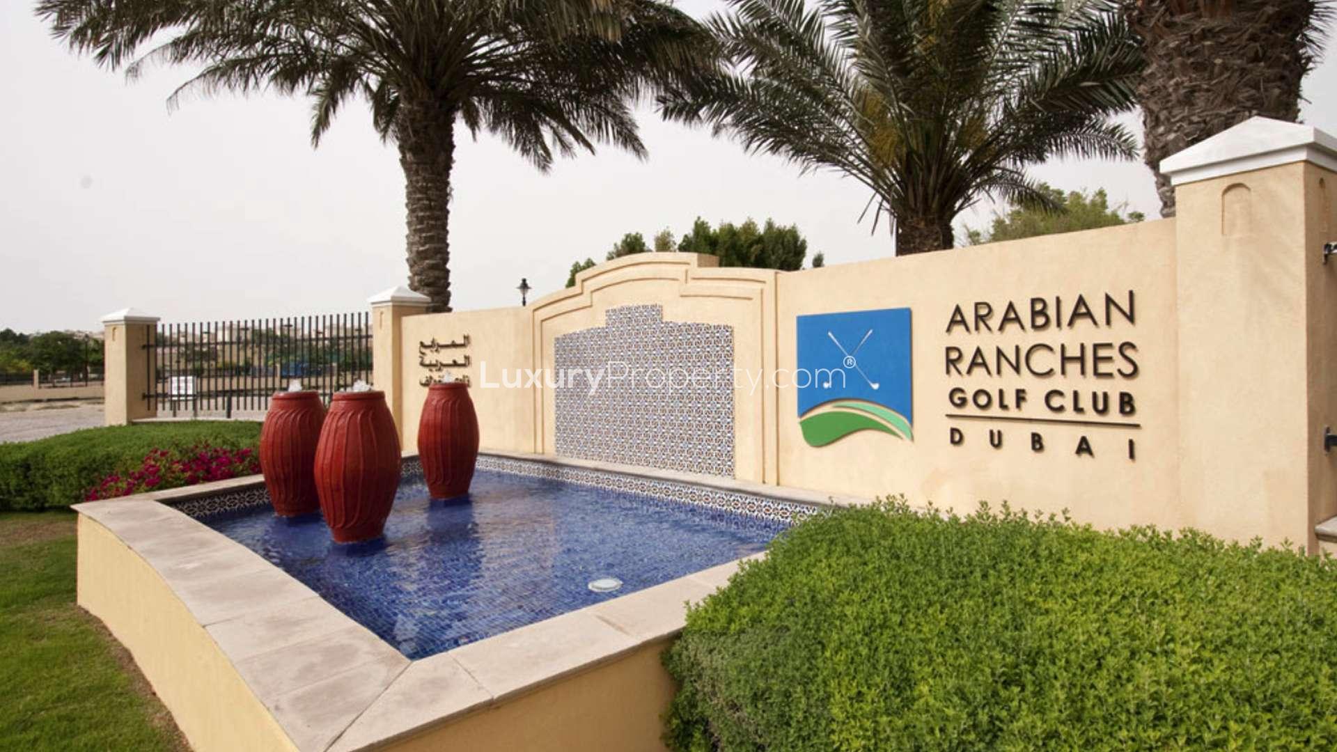 N/A,Entrance to Arabian Ranches Golf Club, decorative fountain with red urns and palm trees