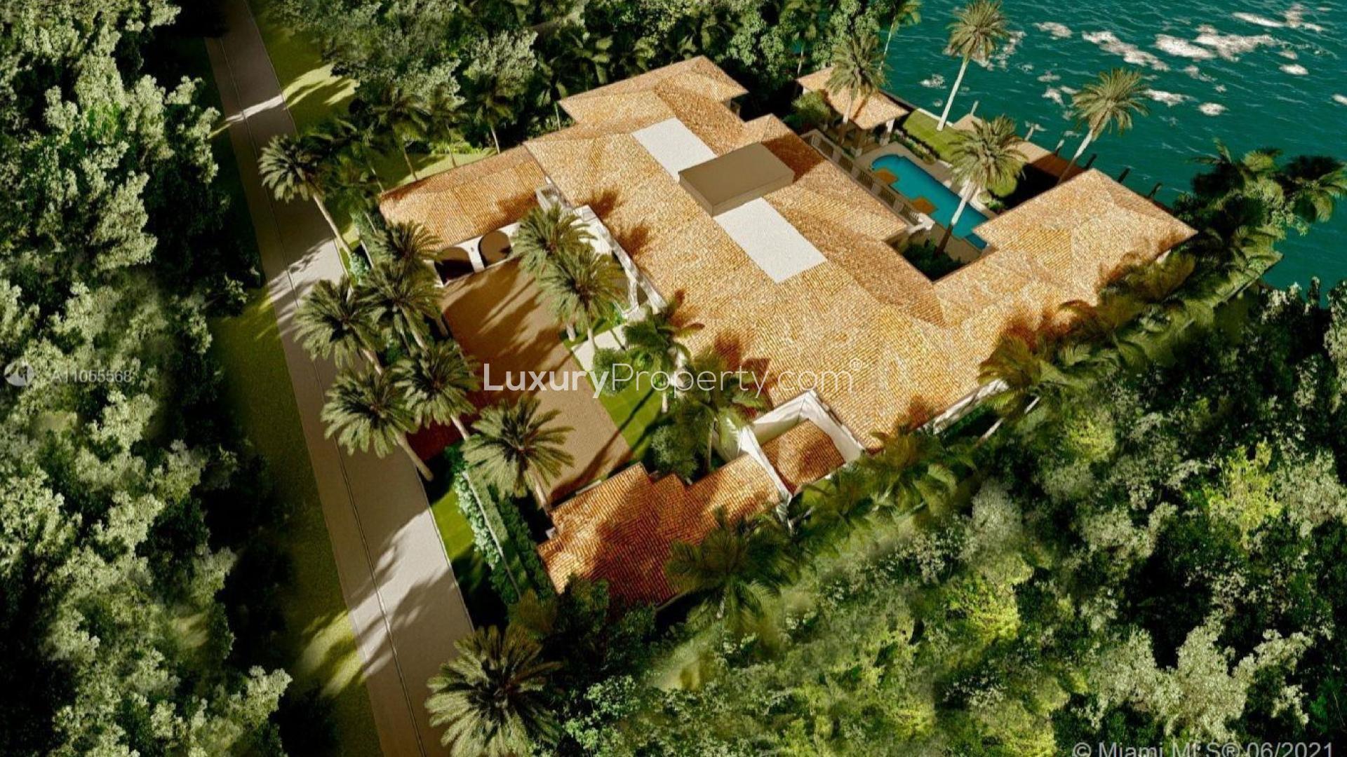 Luxurious Bal Harbour villa with palm trees, elegant facade, prime waterfront location