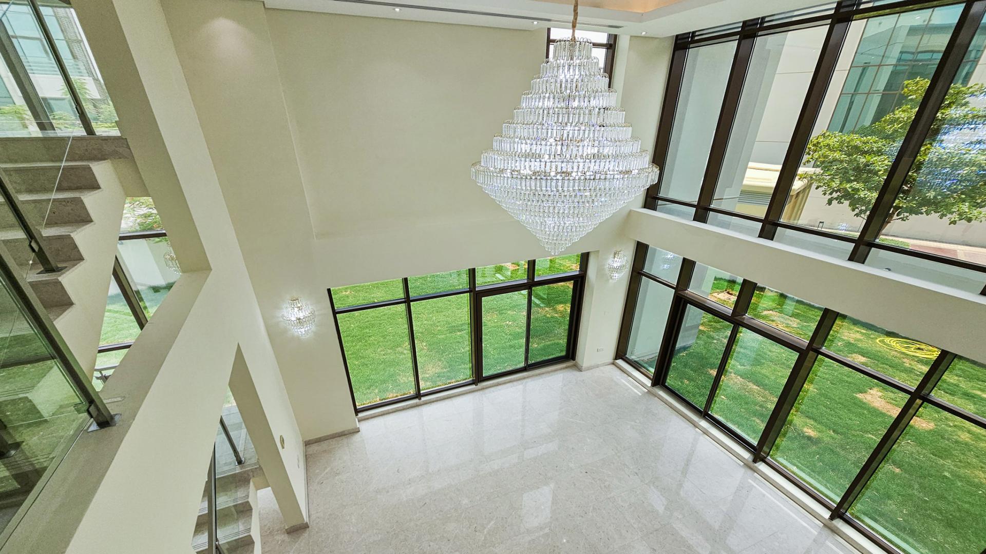 Bright living room with large windows in 6-bedroom villa, Meydan Gated Community