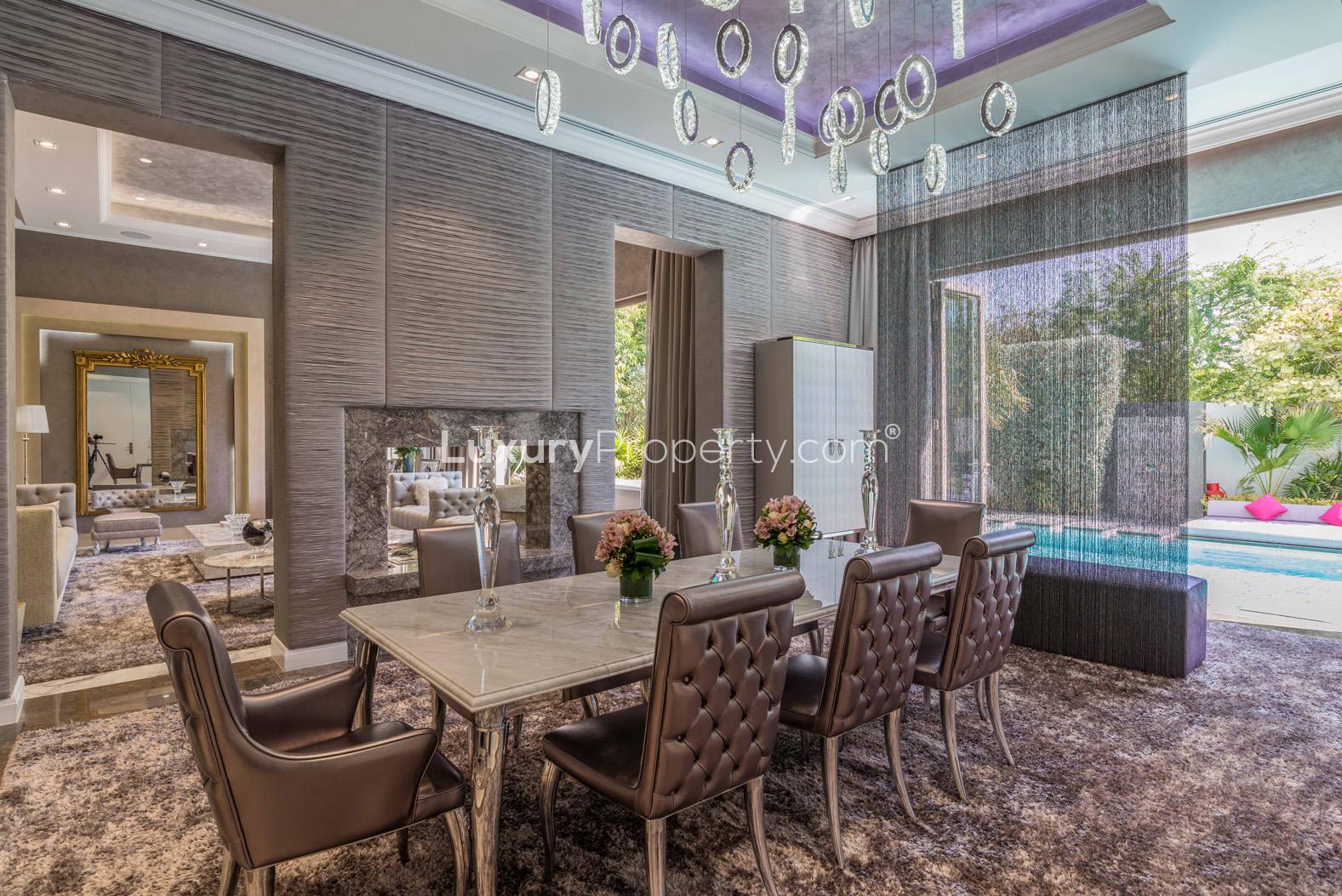 Luxurious Al Barari villa living room with pool view, elegant furnishings, and modern decor