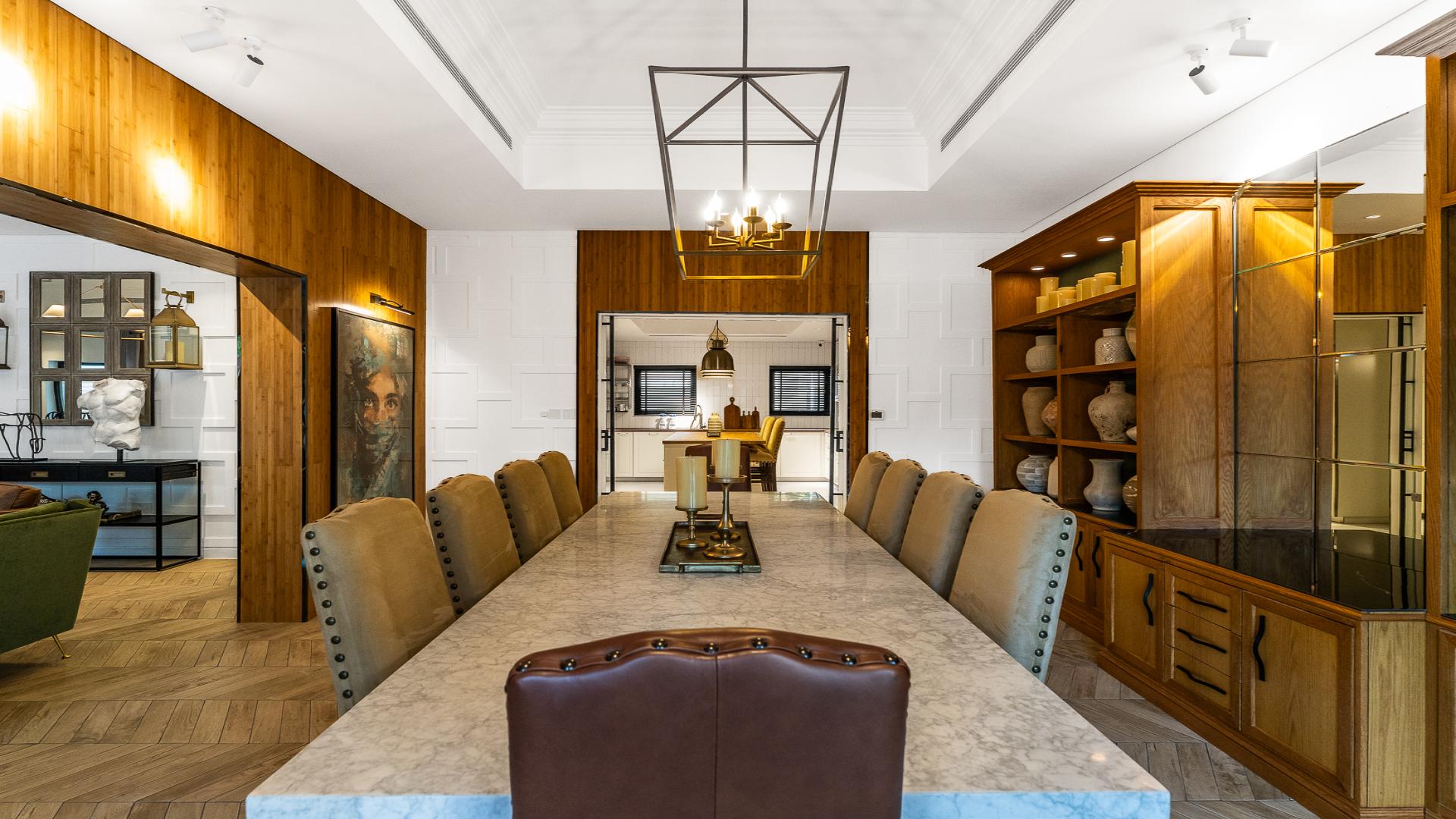 Luxurious dining room in six-bedroom villa, Al Furjan North Village, marble table, elegant decor