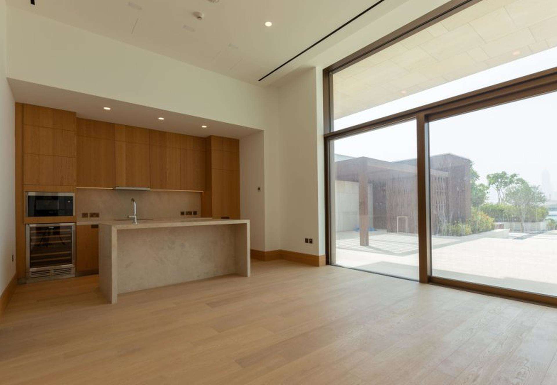 Spacious interior of luxury waterfront villa with wooden staircase, Jumeirah Bay Island views