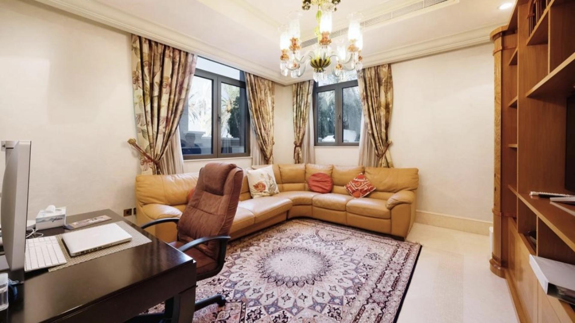 Luxurious modern kitchen in Palm Jumeirah villa for sale, featuring sleek white cabinetry