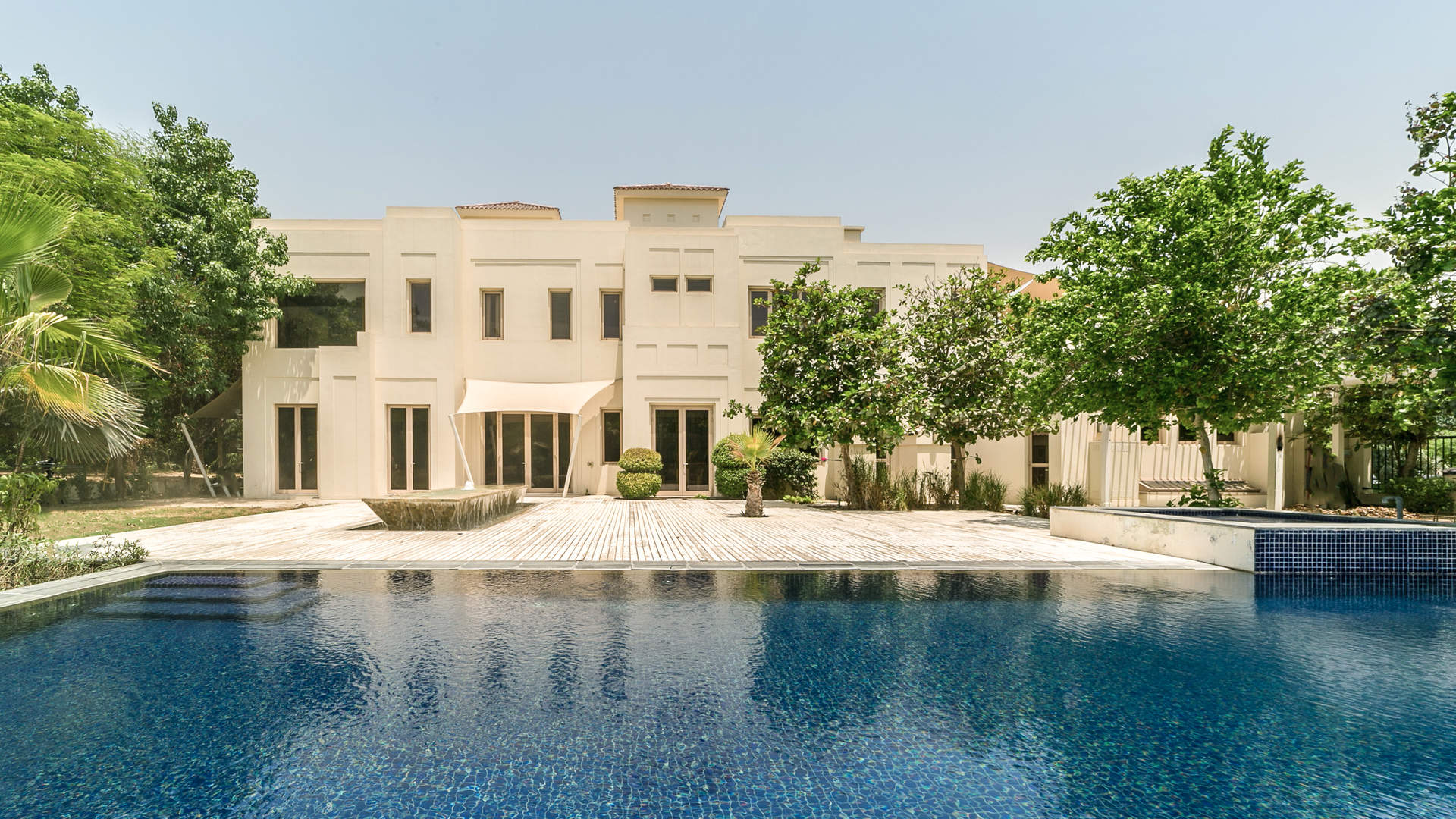 Expansive green lawn and trees at six-bedroom villa, Camellia, Al Barari, Ajman Uptown