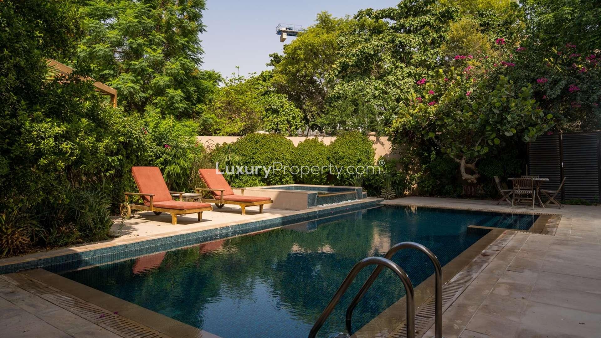 Luxurious living room in 6-bedroom Dahlia Villa, Al Barari, with pool view