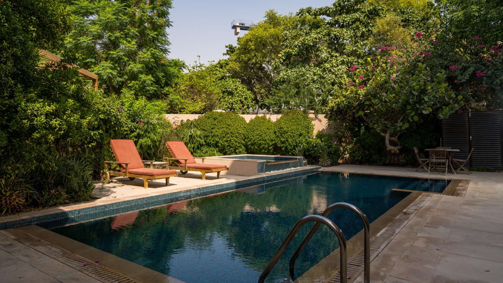 Luxurious living room in 6-bedroom Dahlia Villa, Al Barari, with pool view