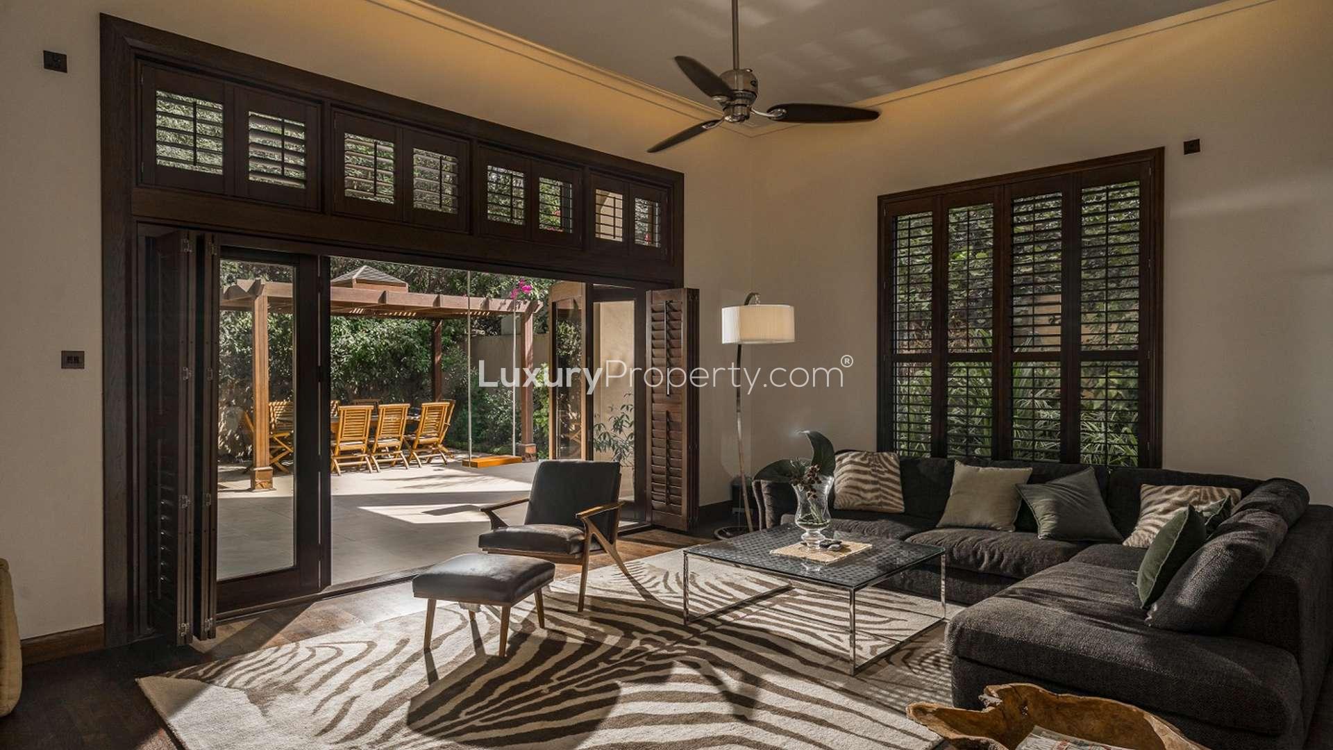 Outdoor patio with wooden pergola and dining set in Dahlia Villa, Al Barari, Dubai