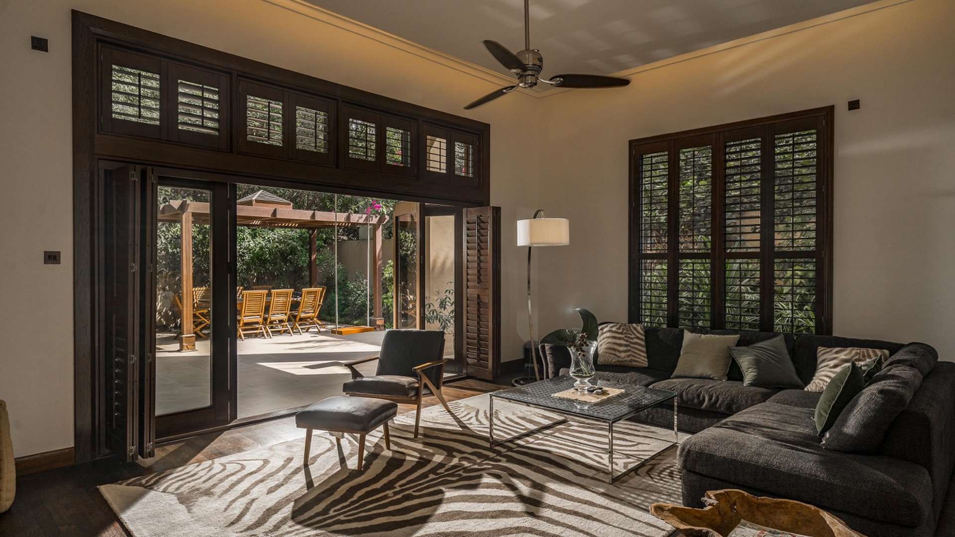 Outdoor patio with wooden pergola and dining set in Dahlia Villa, Al Barari, Dubai