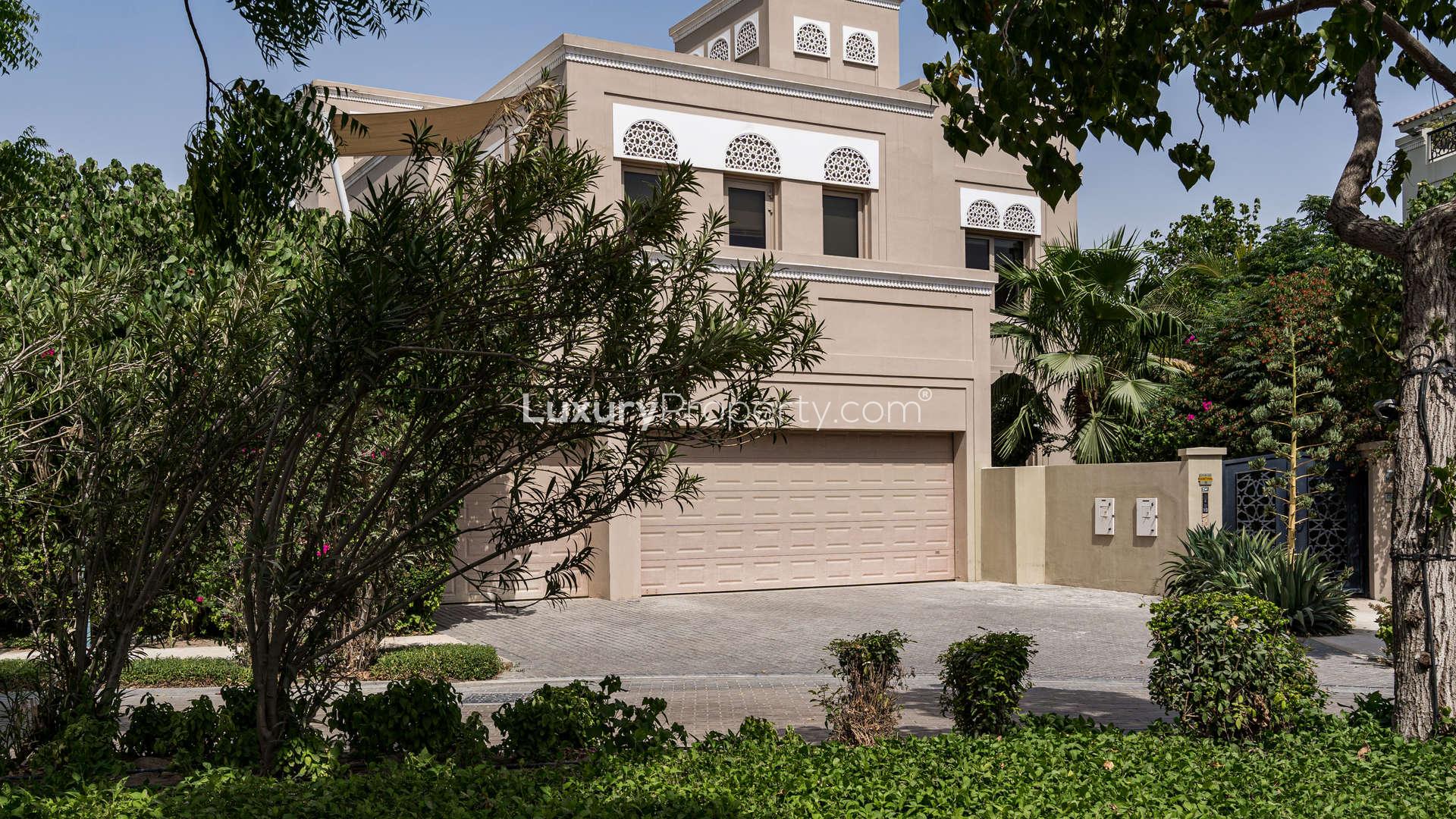 Elegant hallway in Dahlia Villa, Al Barari, featuring dark wood doors and bright flooring