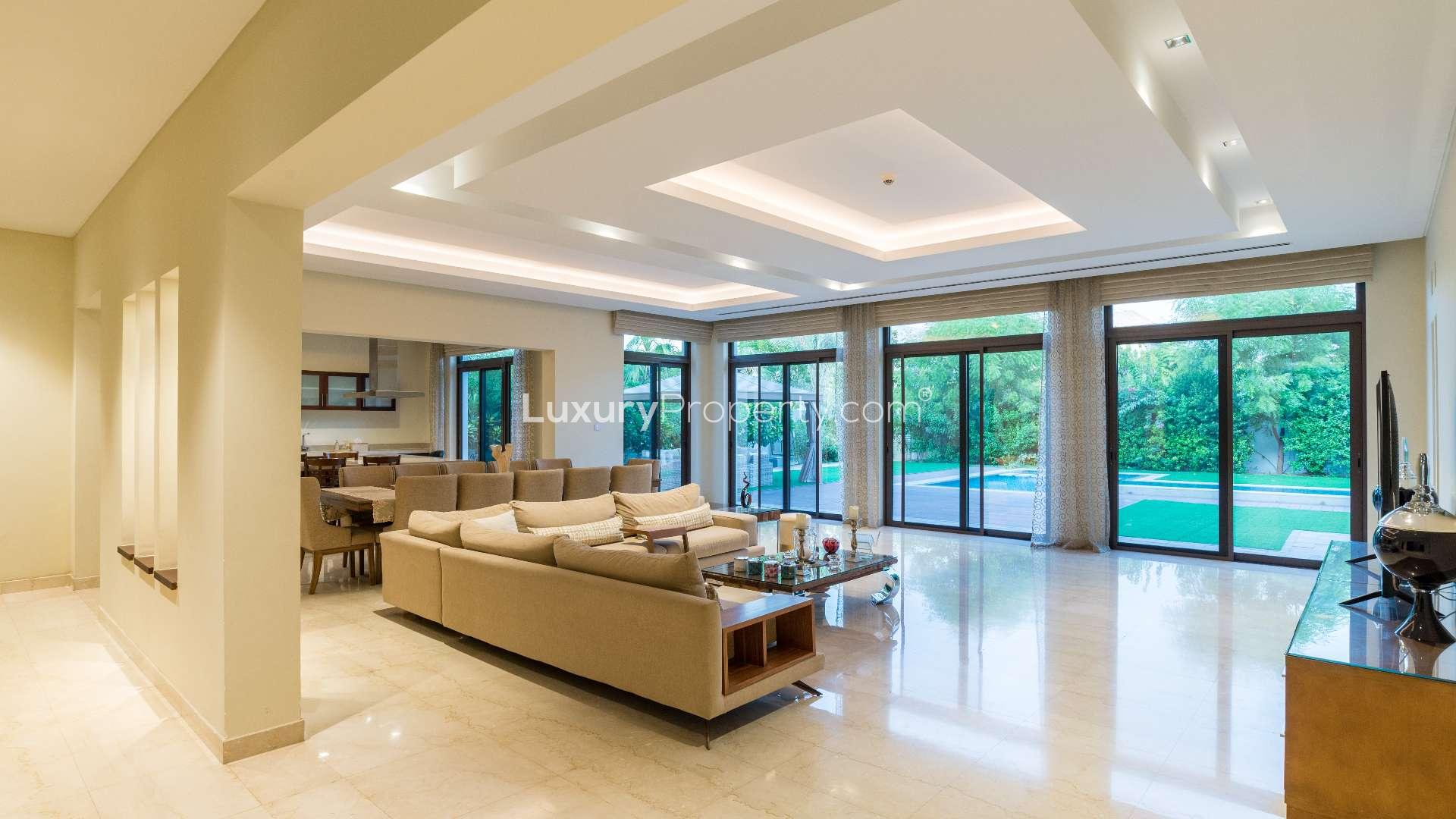 "Spacious balcony view in District One villa, overlooking lush gardens and pool area.",N/A,Luxurious villa living room with modern decor in District One, Mohammed Bin Rashid City