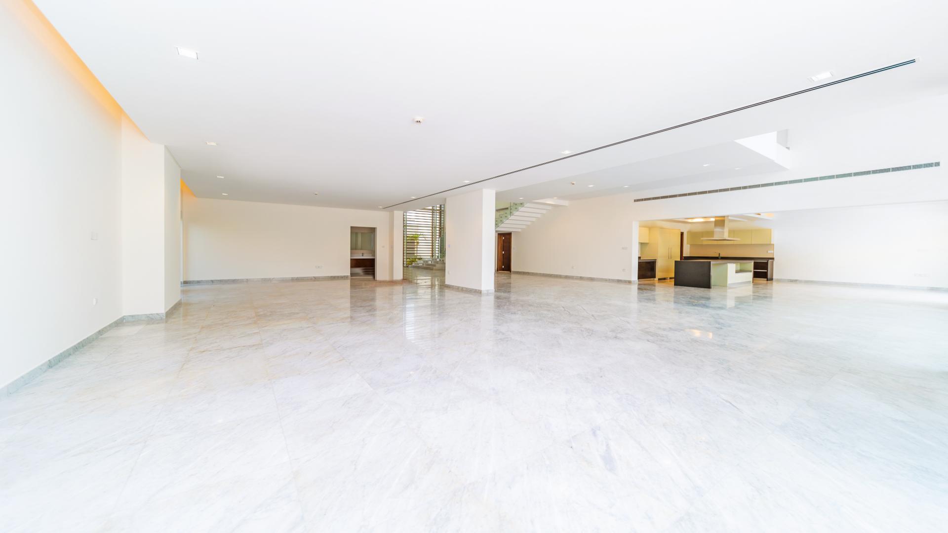 Spacious modern villa interior with marble floors and glass staircase in District One