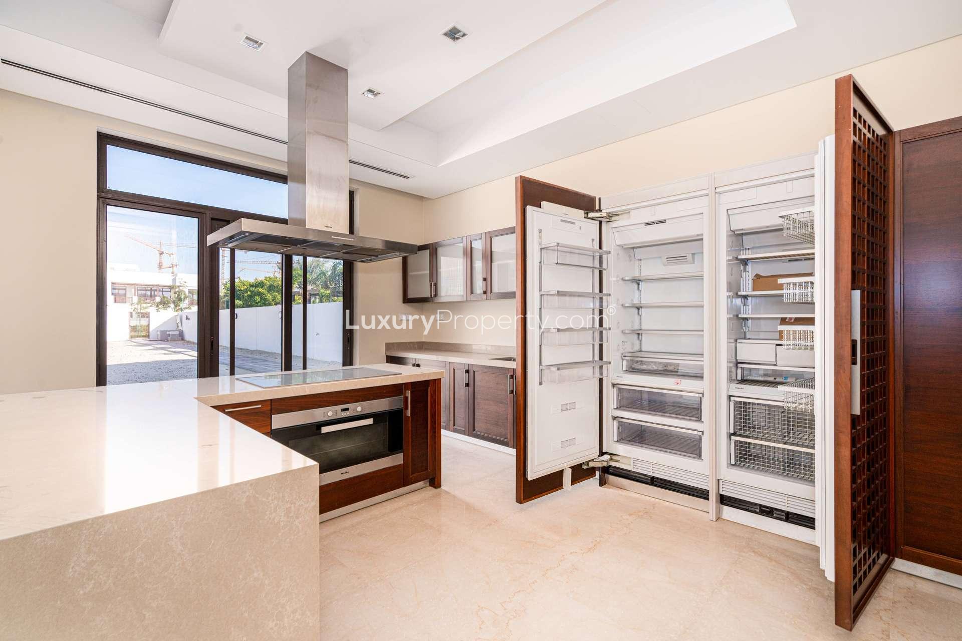 Modern open-plan living area in District One villa, featuring large windows and marble flooring