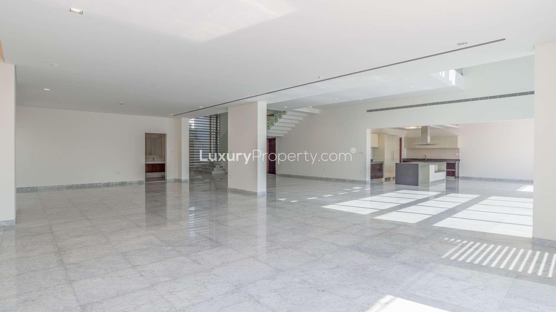 Modern entryway of luxury villa in District One, Dubai, with glass staircase